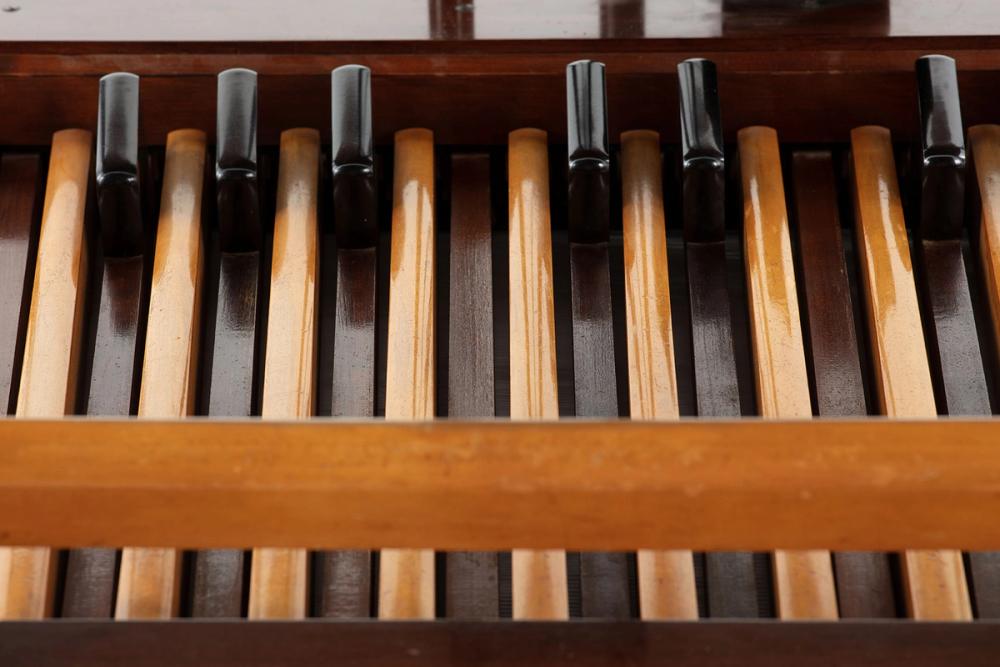 A close up of wooden foot pedals, part of the Hammond organ.