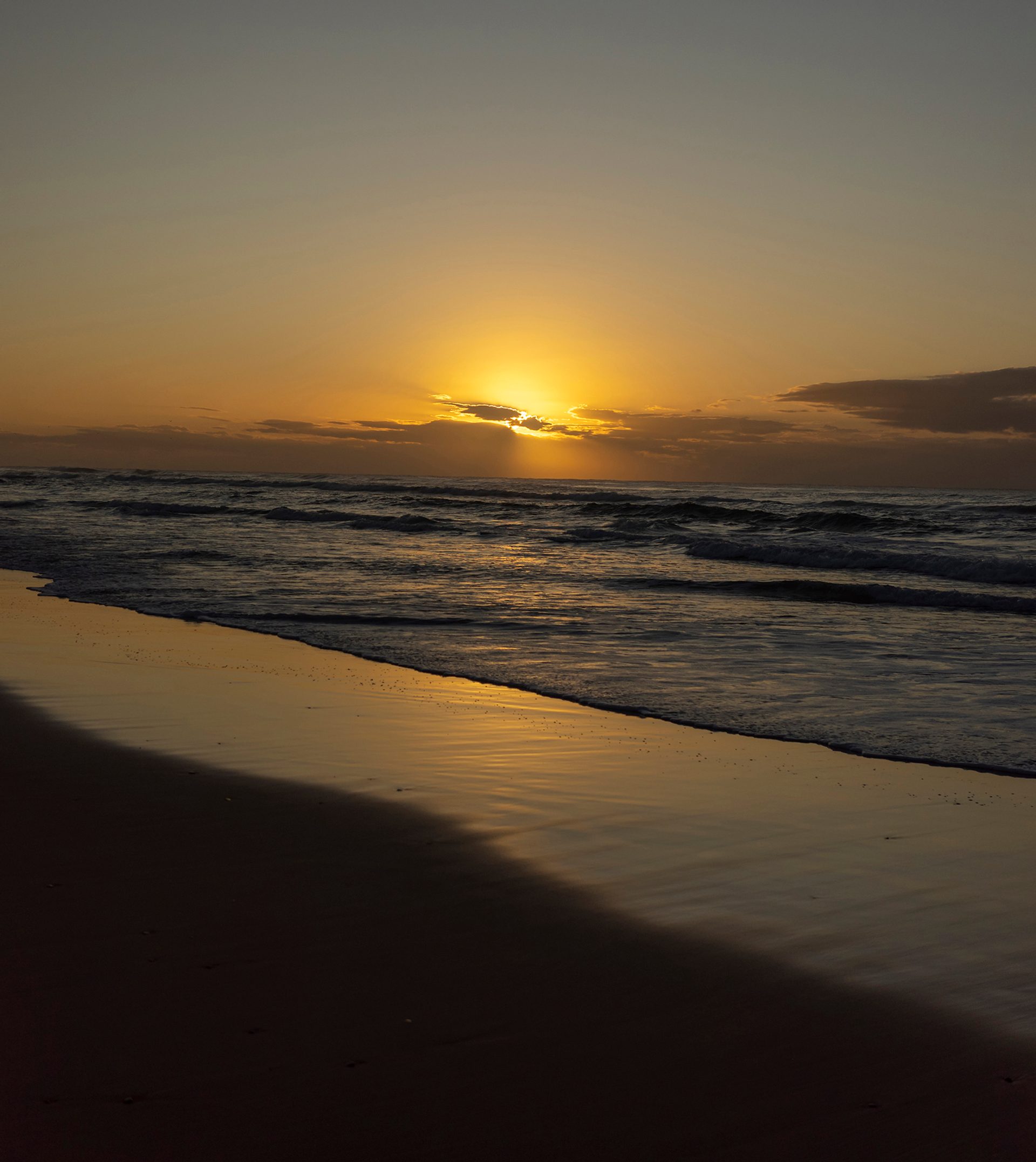 An empty beach at sunset.