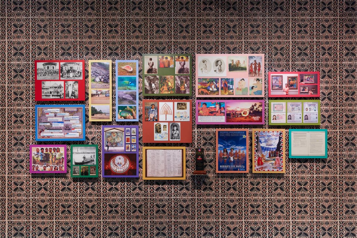 Many framed items on a wall.