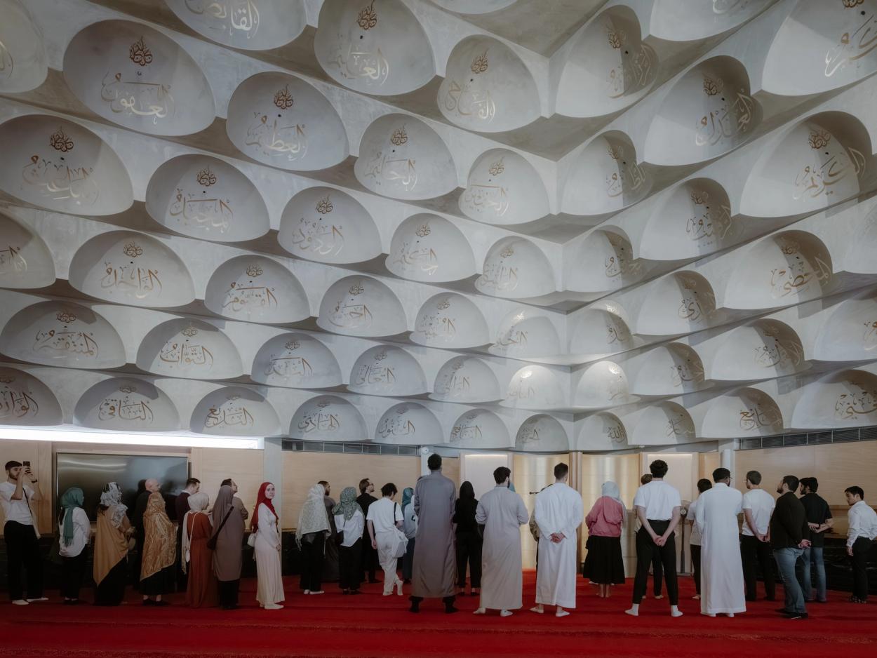 Group of people standing inside the Mosque