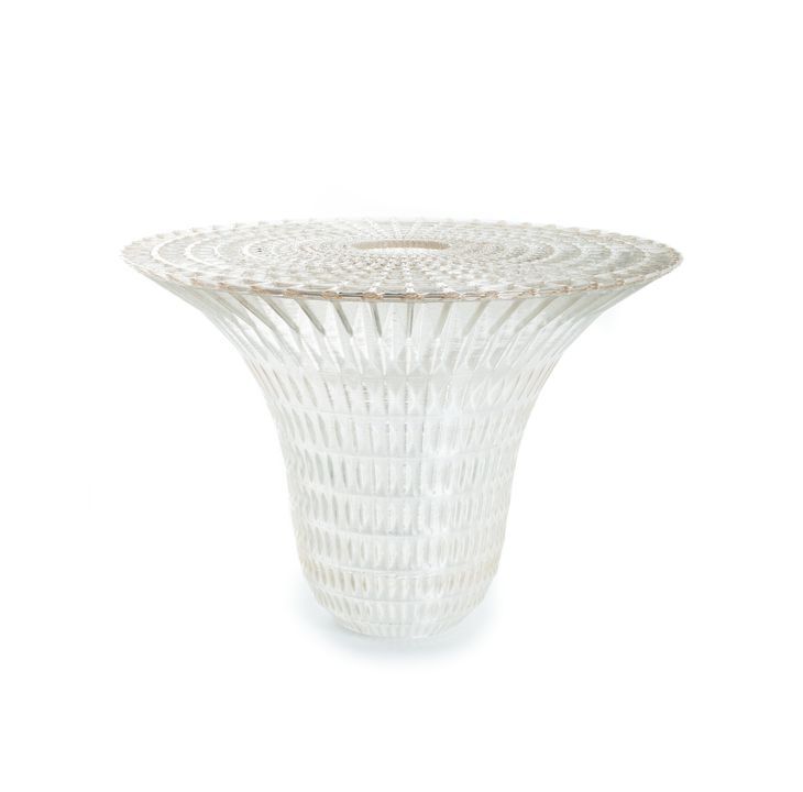 Round, translucent 3-D printed dining table composed as an elaborate open-weave structure.
