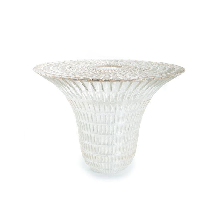Round, translucent 3-D printed dining table composed as an elaborate open-weave structure.