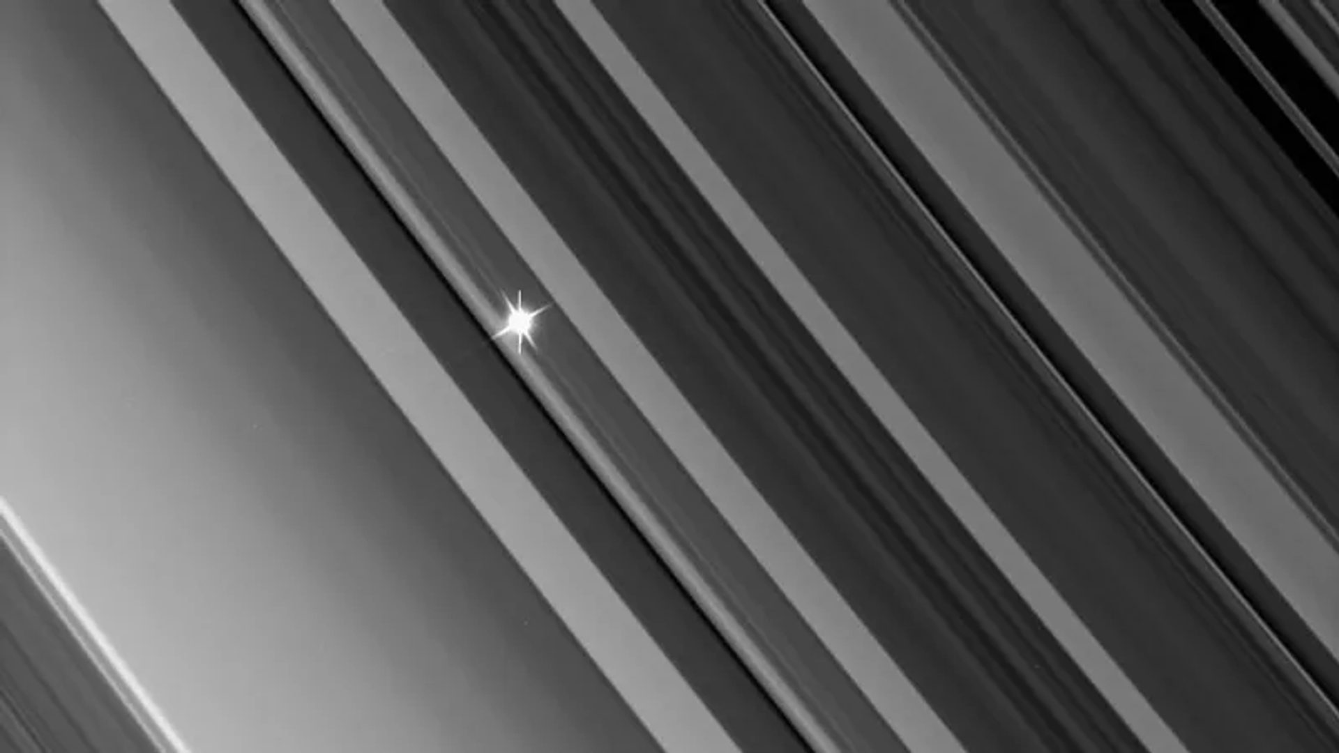 Diagonal line from top left to bottom, right. A bright star shines through them.