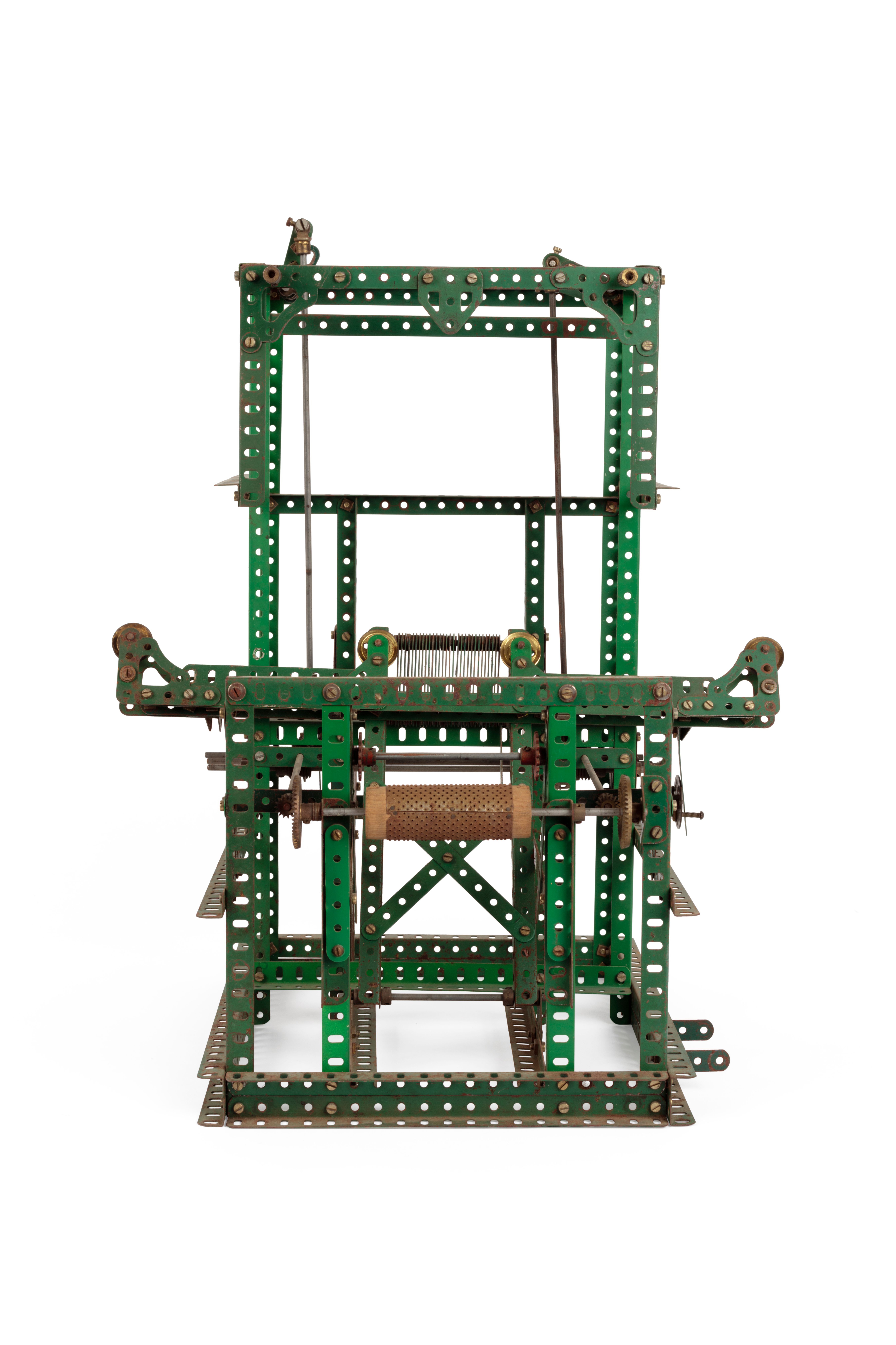 Meccano model of Jacquard loom, a intricate metal structure made of green strips with holes along them.