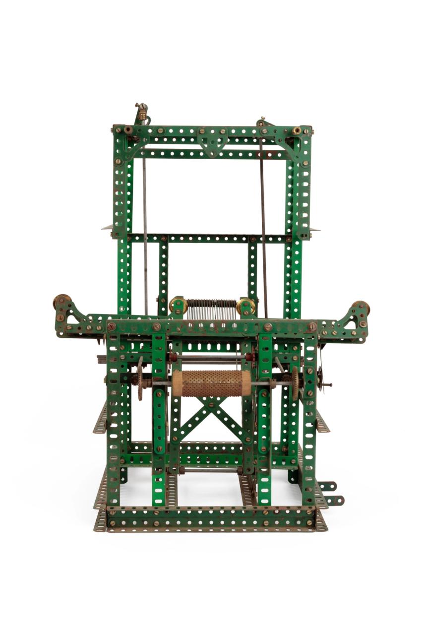 Meccano model of Jacquard loom, a intricate metal structure made of green strips with holes along them.