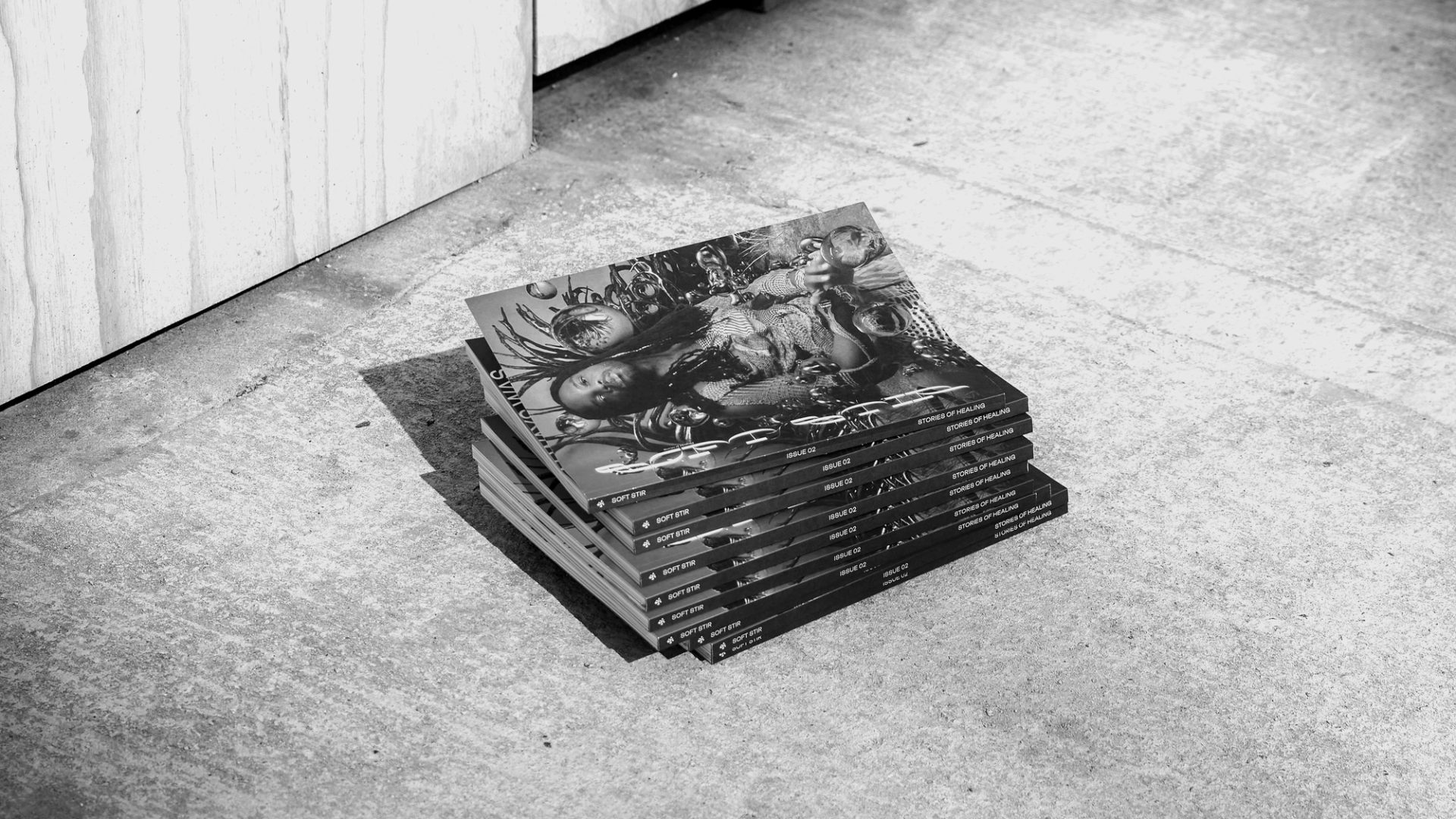 Black and white image of a stack of magazines