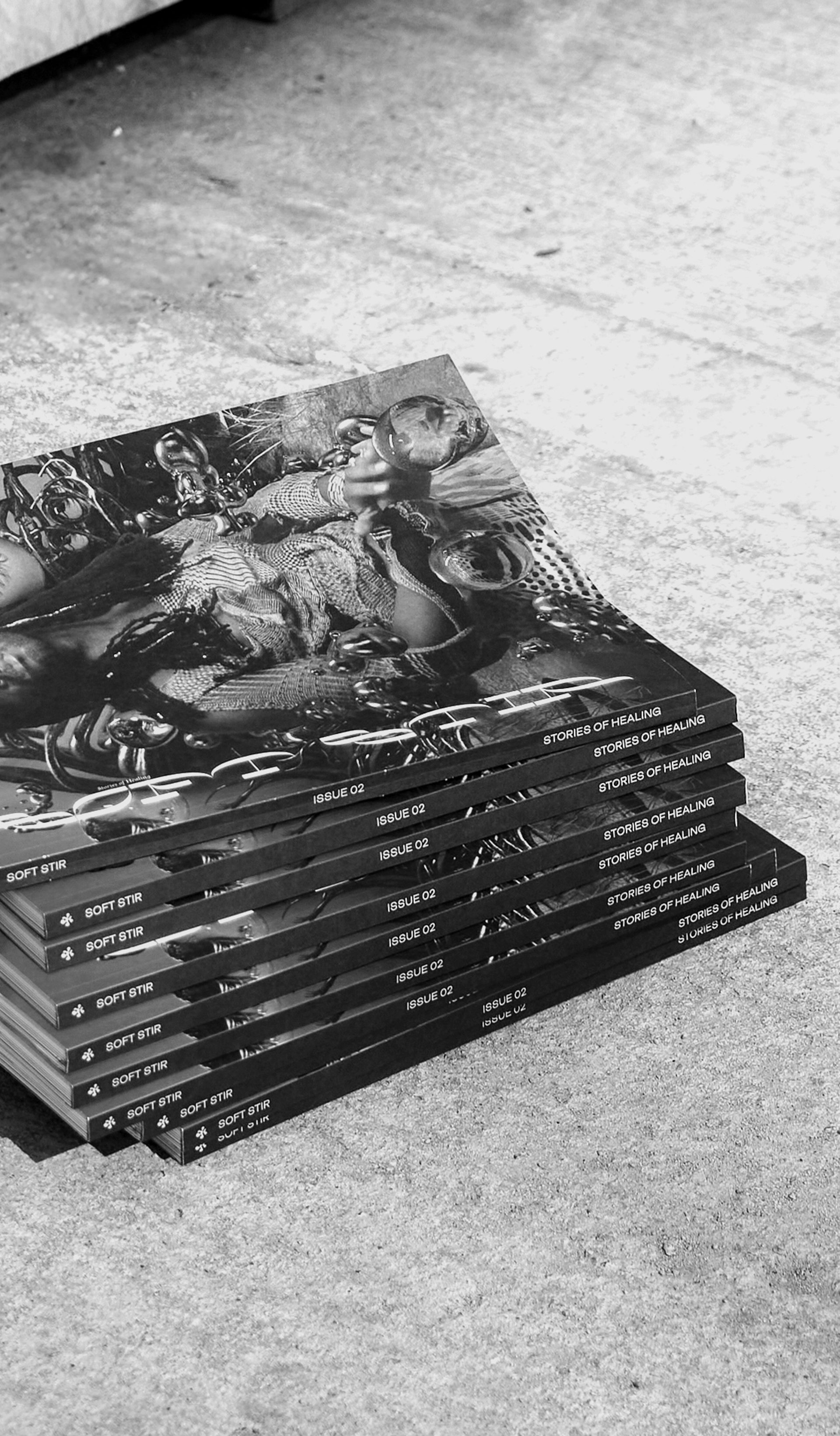 Black and white image of a stack of magazines