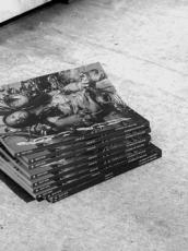 Black and white image of a stack of magazines
