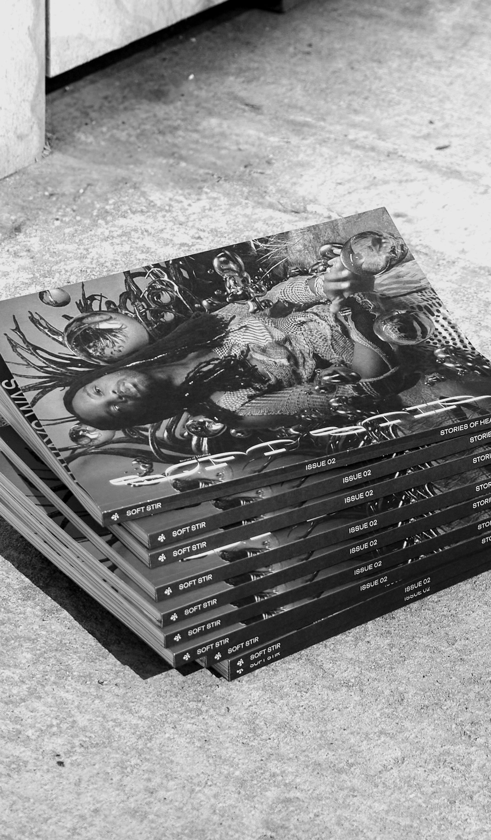 Black and white image of a stack of magazines