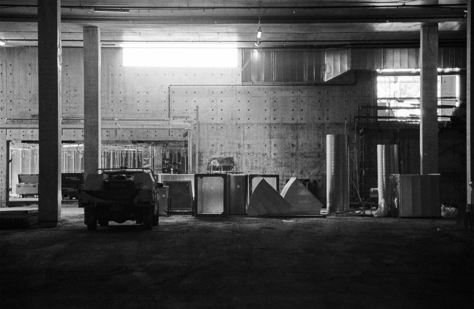 Black and white photograph of the Castle Hill site with a small truck to the left, and materials to the right