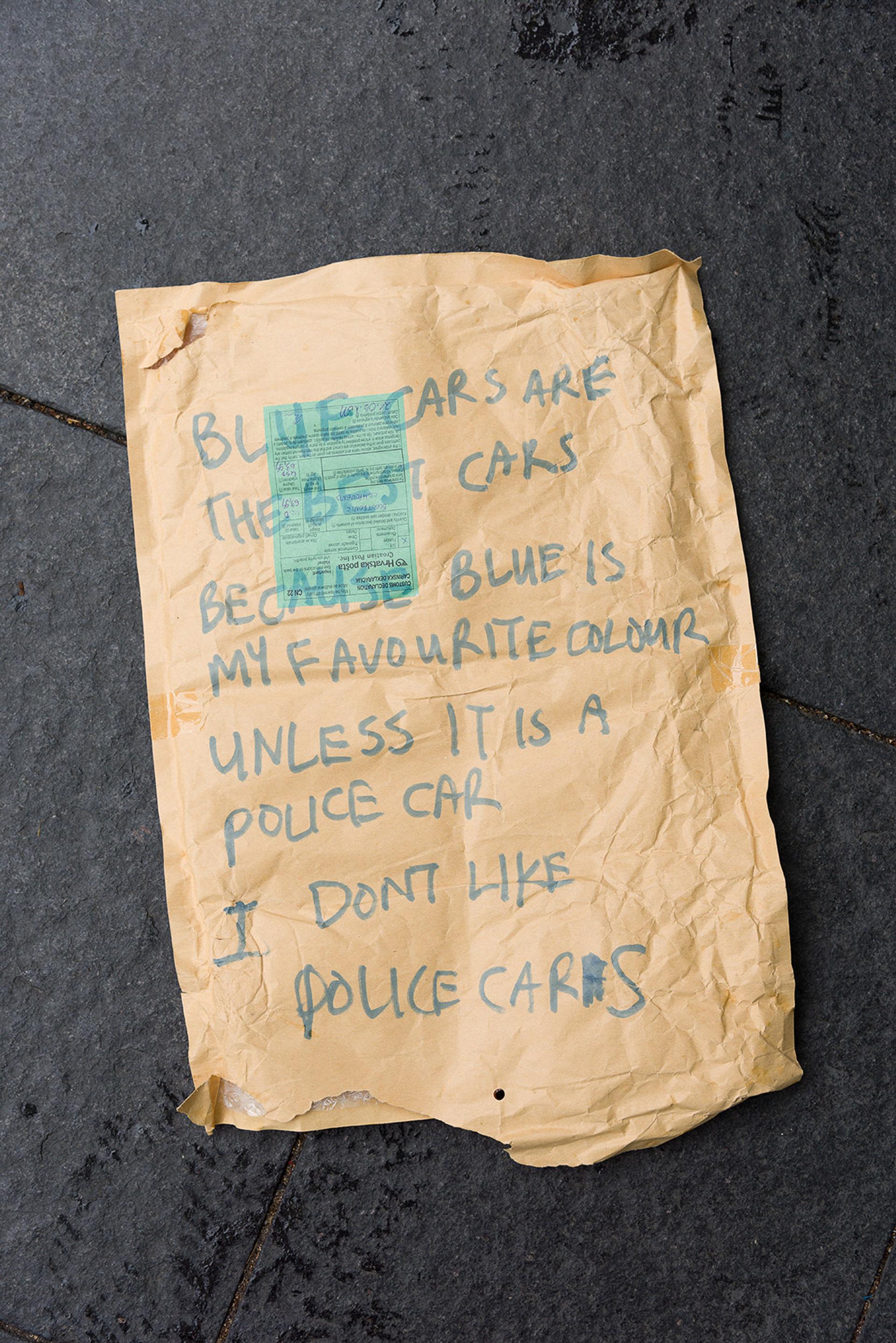 Note reading “BLUE CARS ARE THE BEST CARS BECAUSE BLUE IS MY FAVOURITE COLOUR UNLESS IT IS A POLICE CAR I DON’T LIKE POLICE CARS”