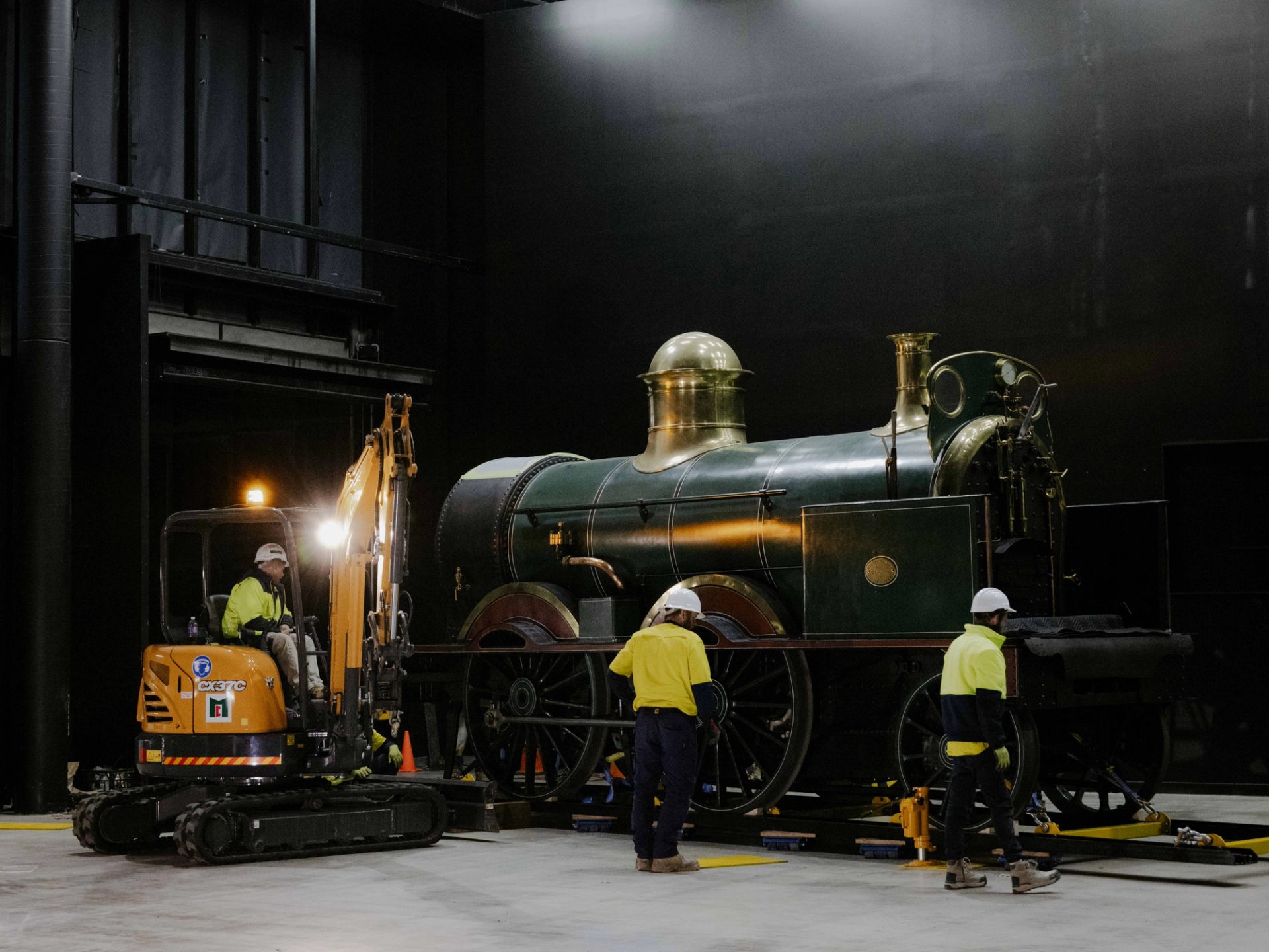 Tradepeople surrounding a train on a track.
