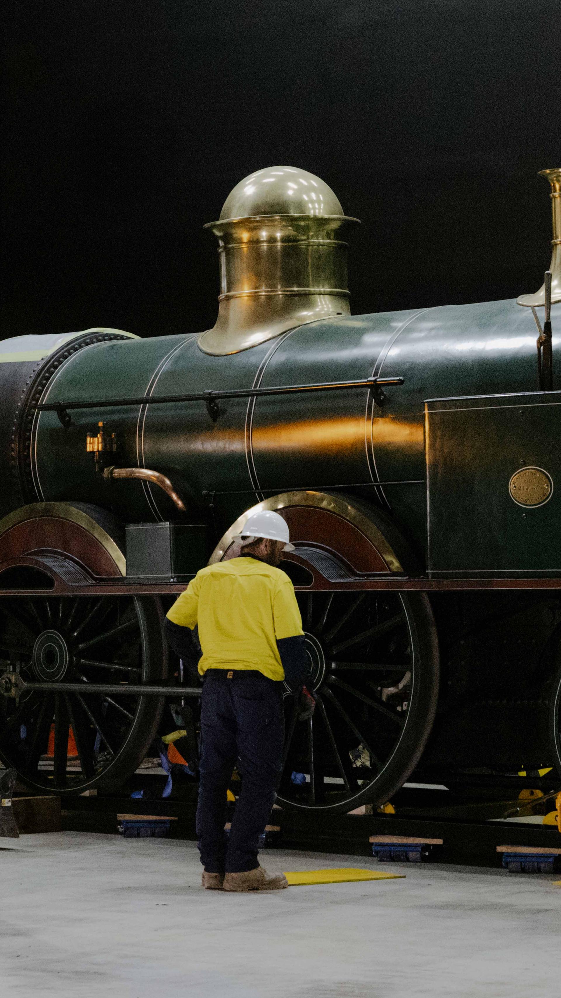 Tradepeople surrounding a train on a track.