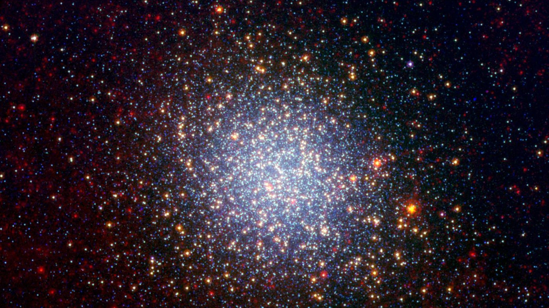 A cluster brimming with millions of stars glistens like an iridescent opal in this image from NASA Spitzer Space Telescope.