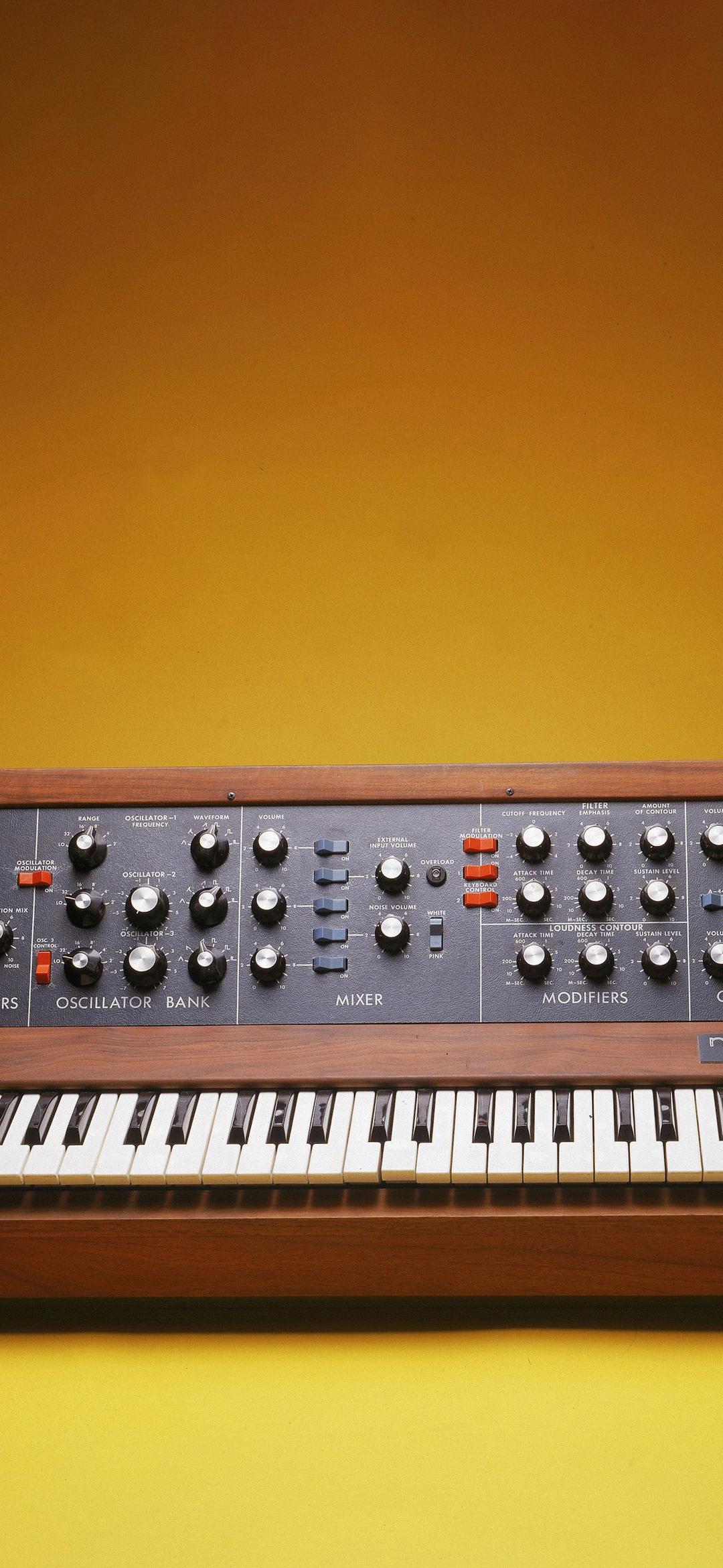 Minimog synthesizer on a yellow background in a photobooth