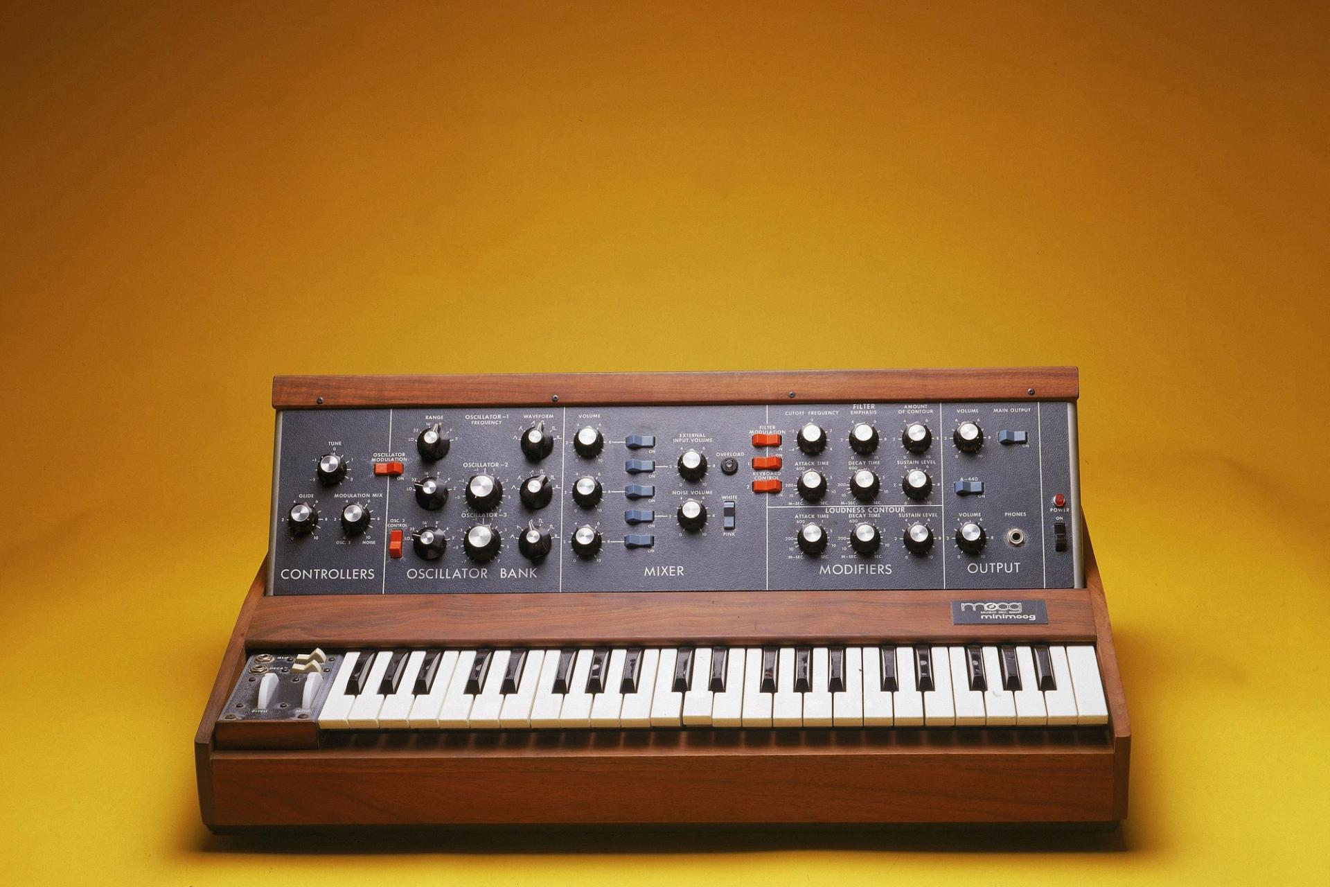 Minimog synthesizer on a yellow background in a photobooth