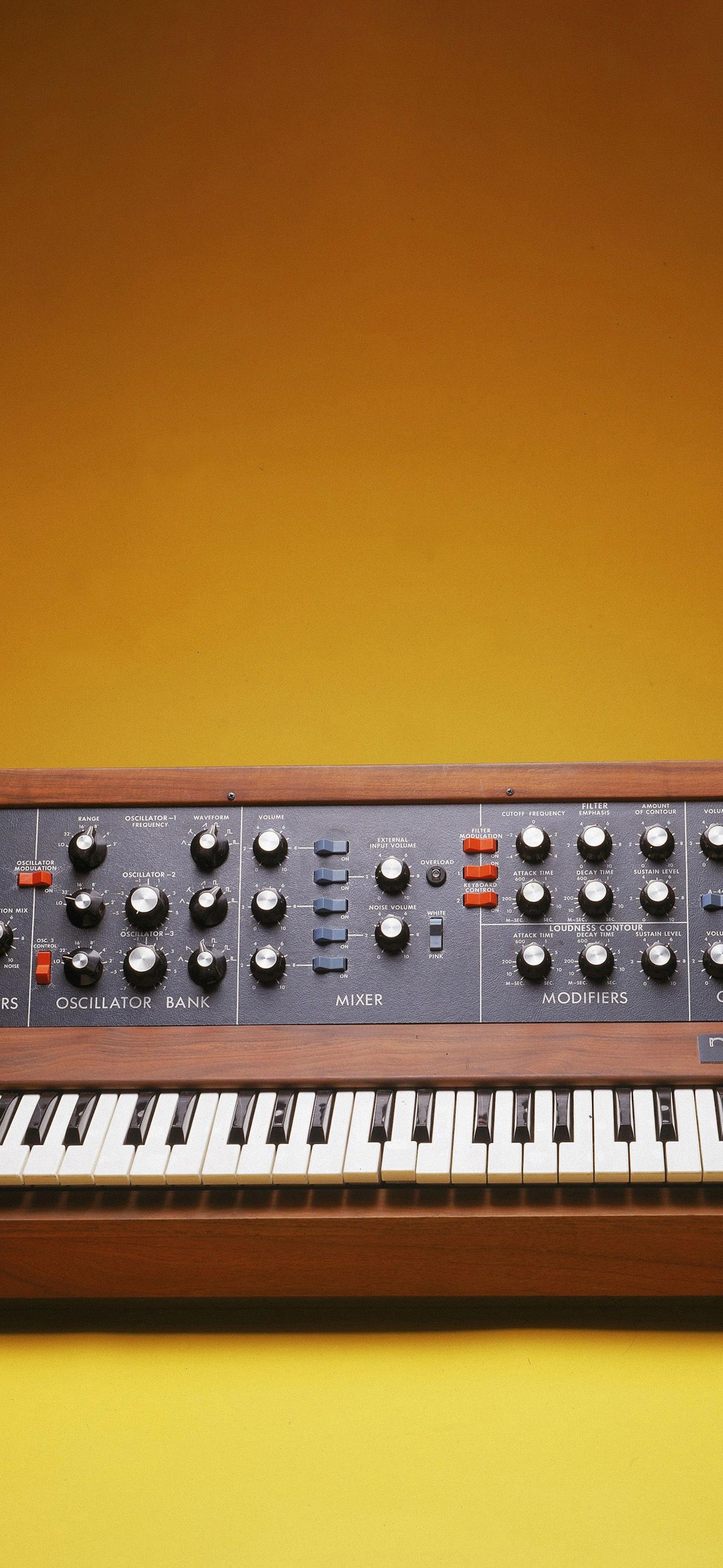 Minimog synthesizer on a yellow background in a photobooth