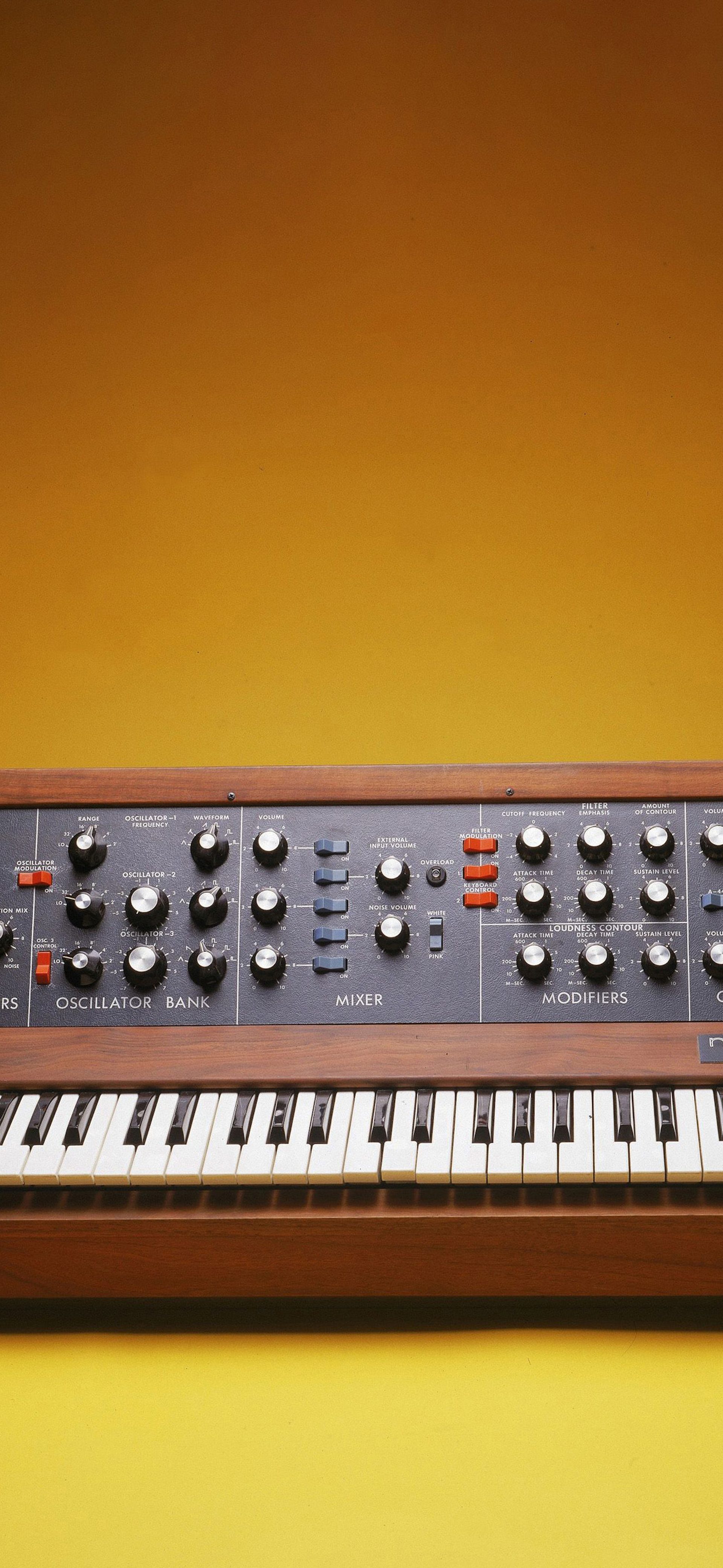 Minimog synthesizer on a yellow background in a photobooth