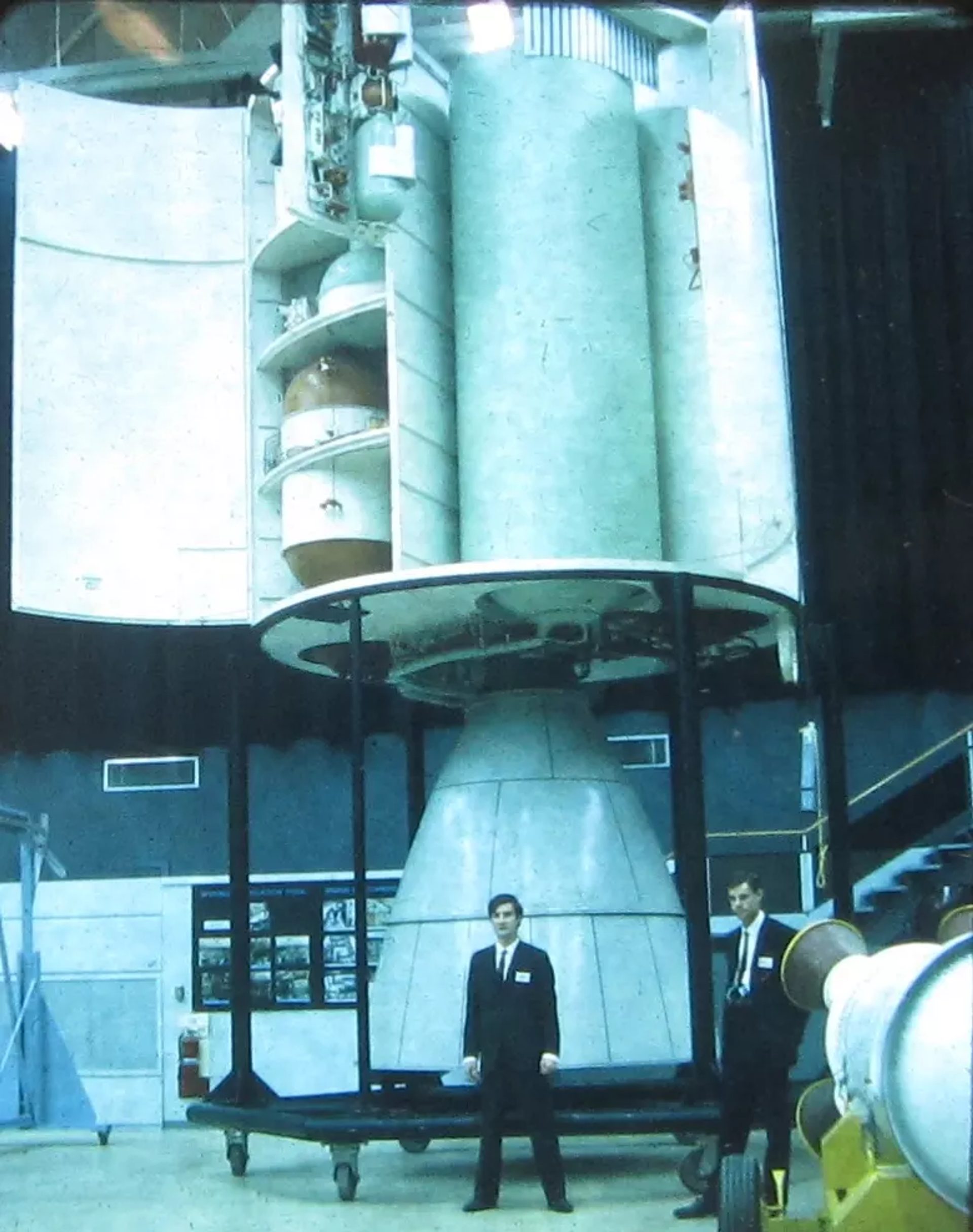 Big rocket, small figures infront.