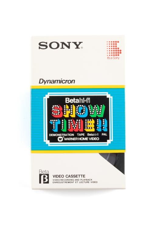 Sony Beta video cassette in a cardboard sleeve. Text on the front includes 'Beta hi-fi SHOW TIME!! Demonstration Tape Warner Home Video'