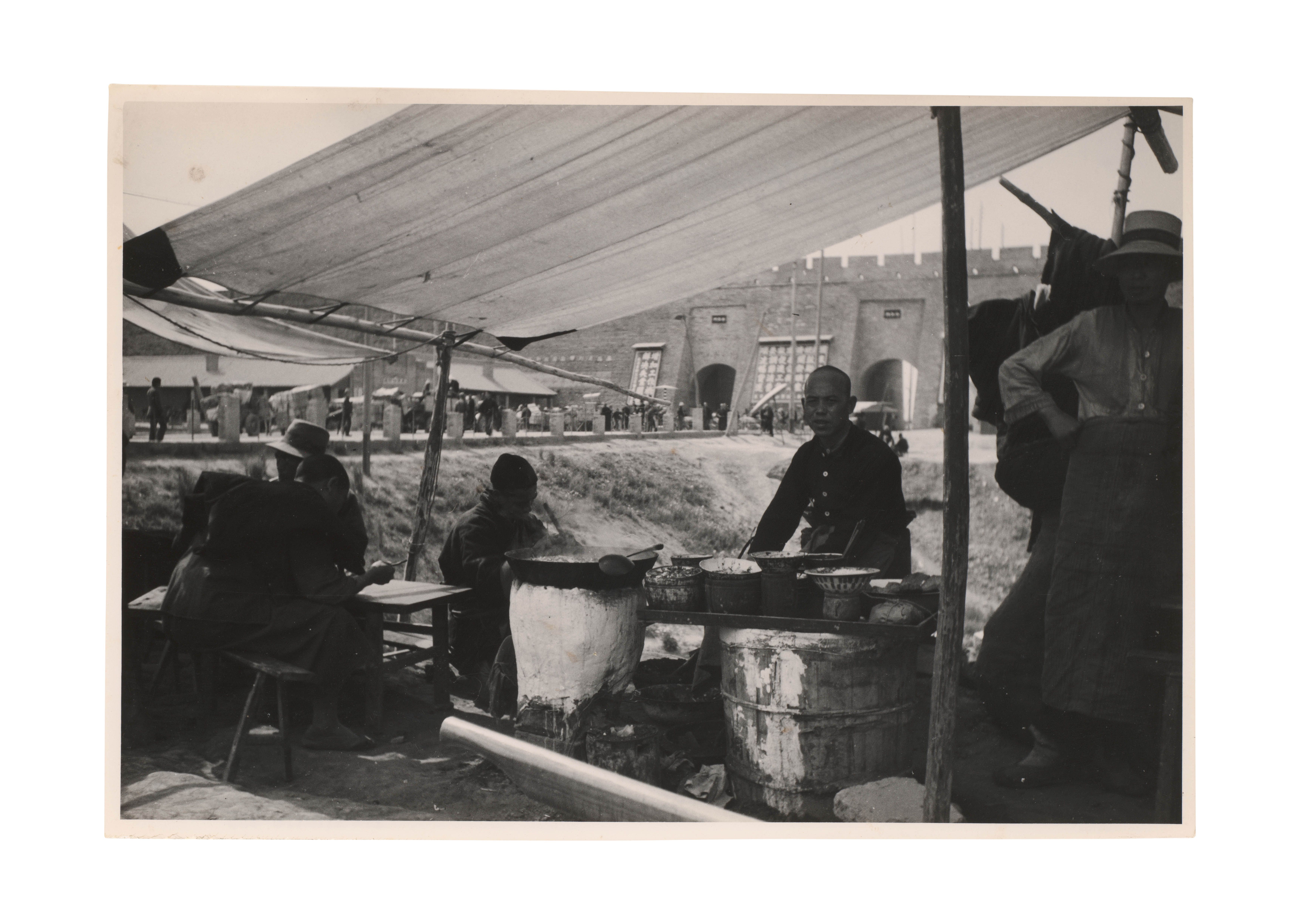 China markets around 1911, an outdoor food stall under a canopy.