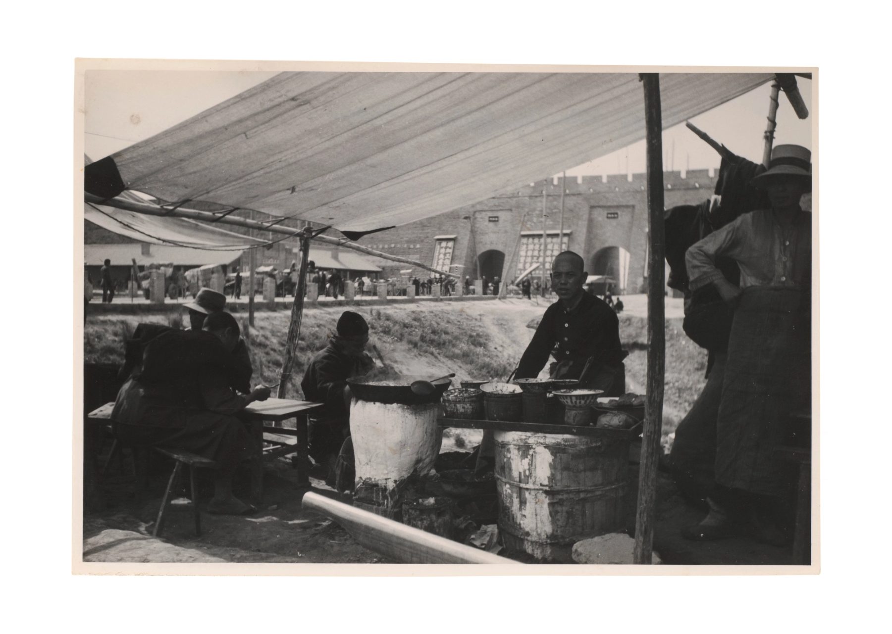 China markets around 1911, an outdoor food stall under a canopy.