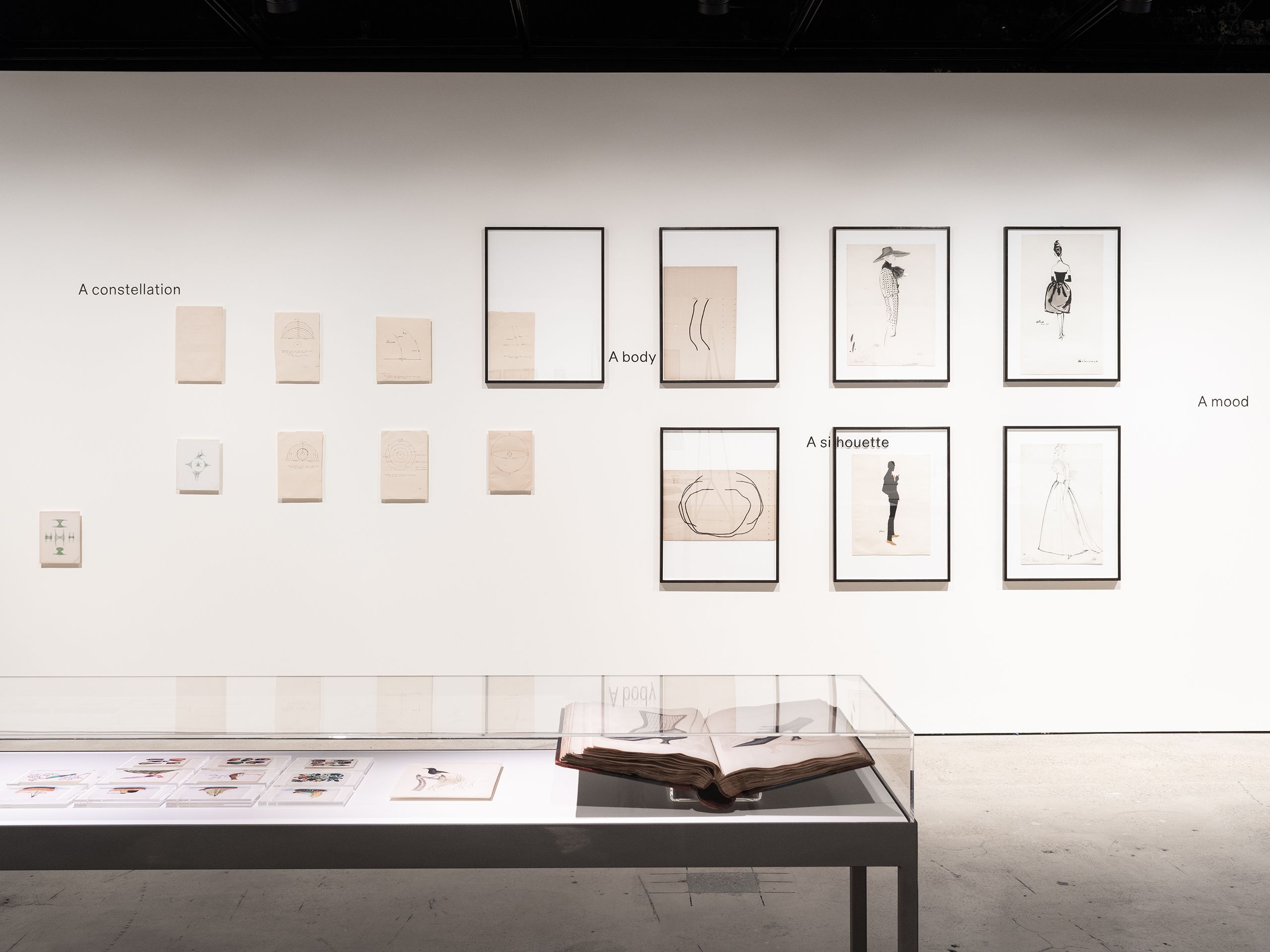 Installation view featuring Balenciaga fashion illustrations, celestial objects, Chinese rice paper drawings and Joseph Box shoe archive.