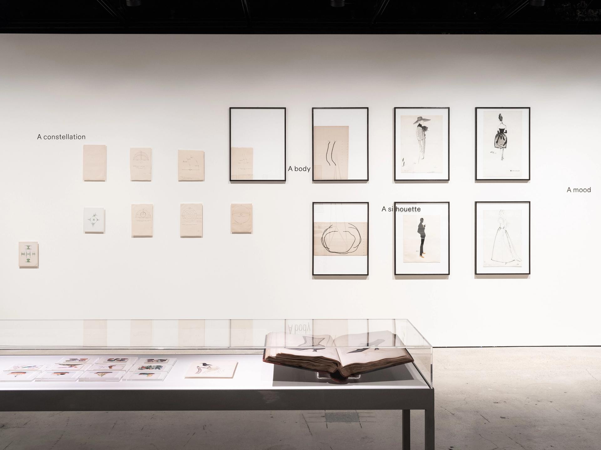 Installation view featuring Balenciaga fashion illustrations, celestial objects, Chinese rice paper drawings and Joseph Box shoe archive.