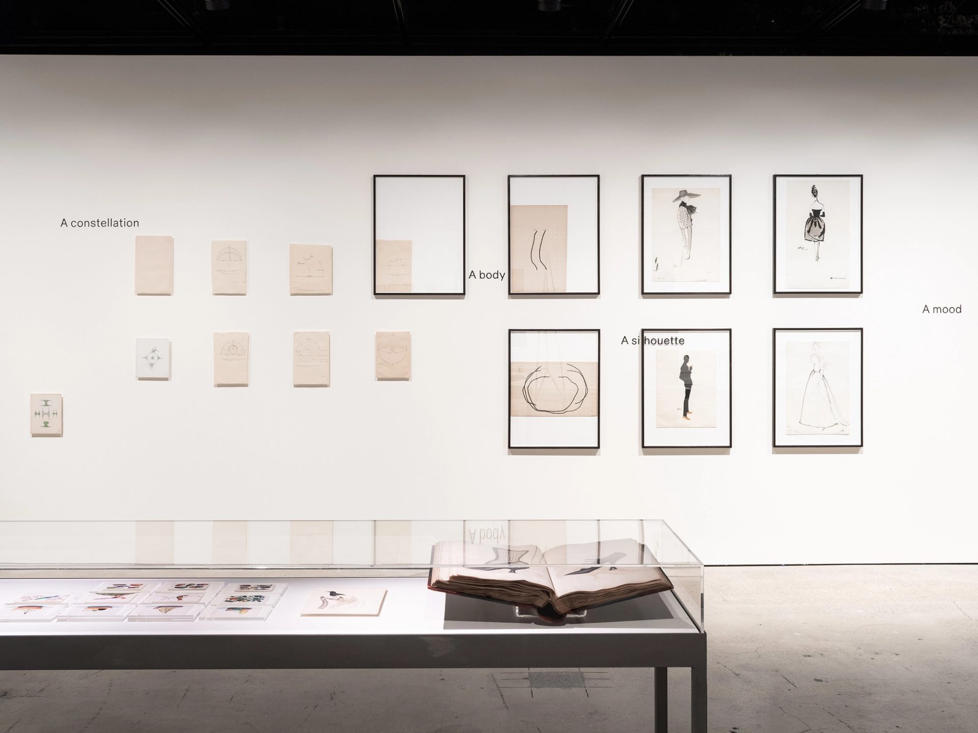 Installation view featuring Balenciaga fashion illustrations, celestial objects, Chinese rice paper drawings and Joseph Box shoe archive.