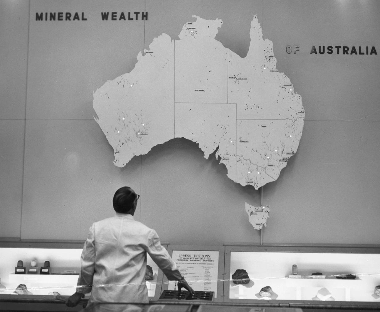 Large interactive map of Australia with operated by a person in a white shirt standing in front of some buttons