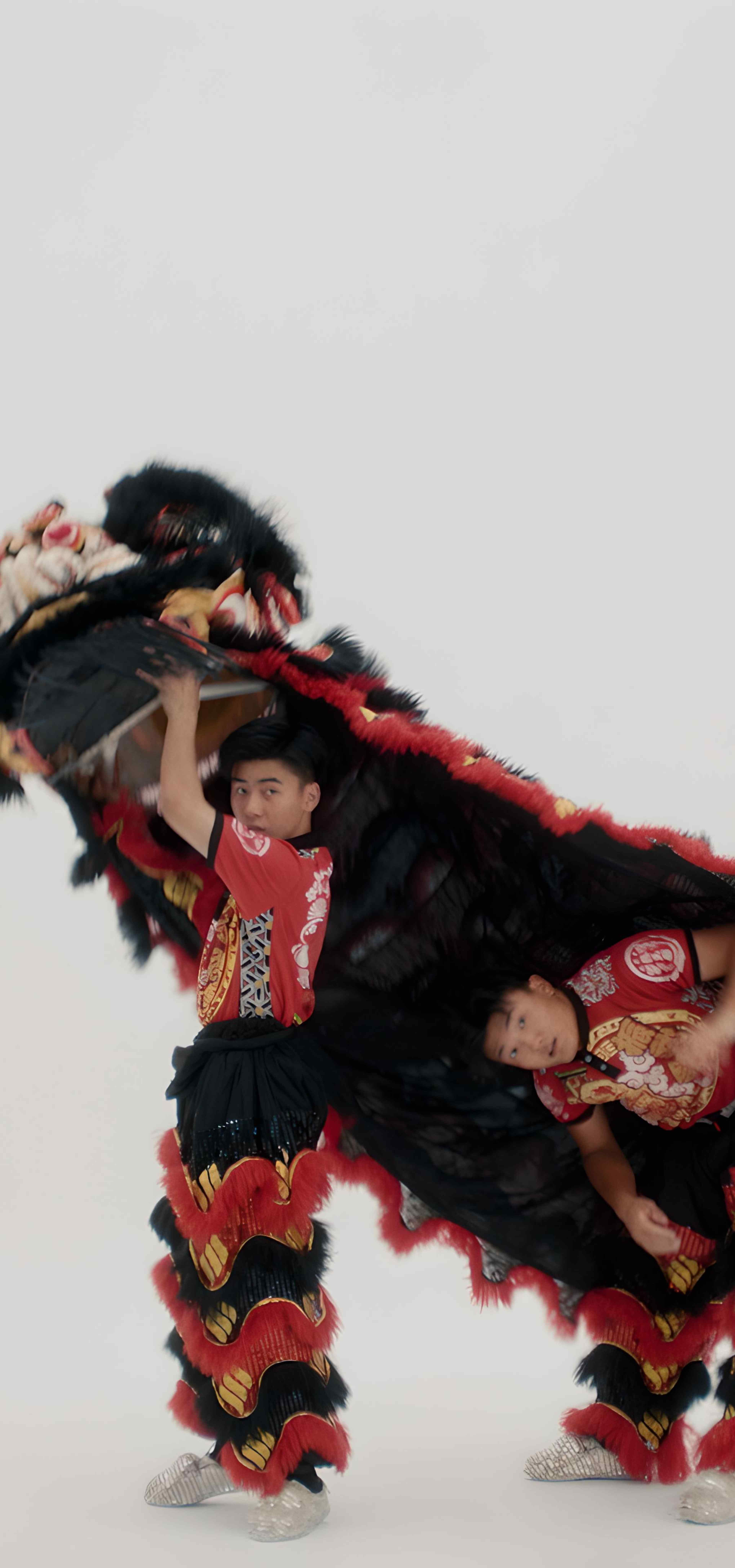 Two men coming out from under a lion costume