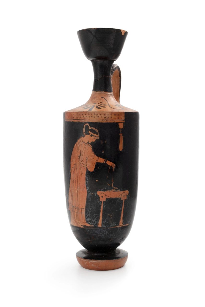 Red earthenware jug with an image of a person in a long robe and their black hair in a headband.