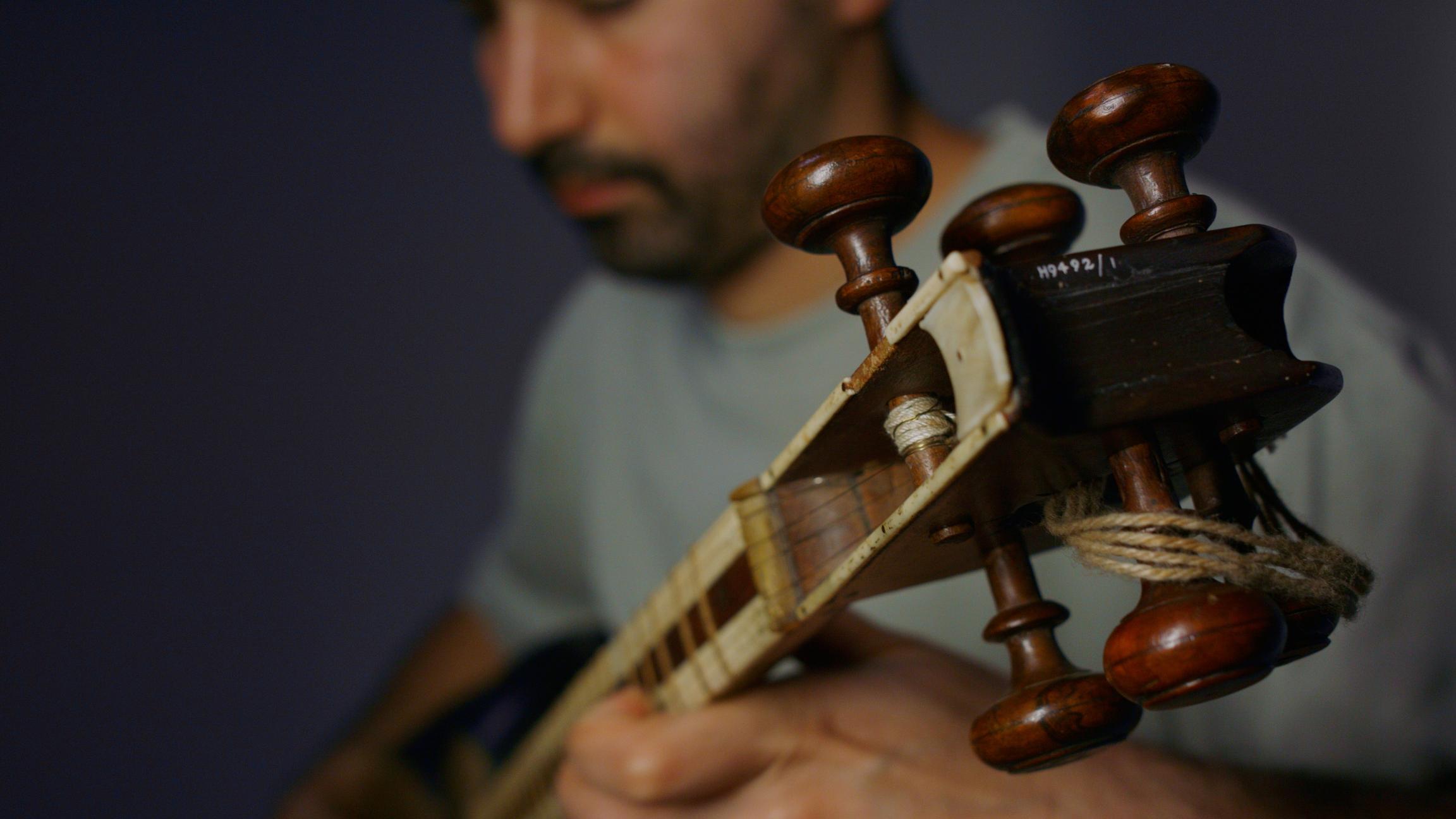 A close up of the top of the neck of the tar which is being played by Hamed Sadeghi.