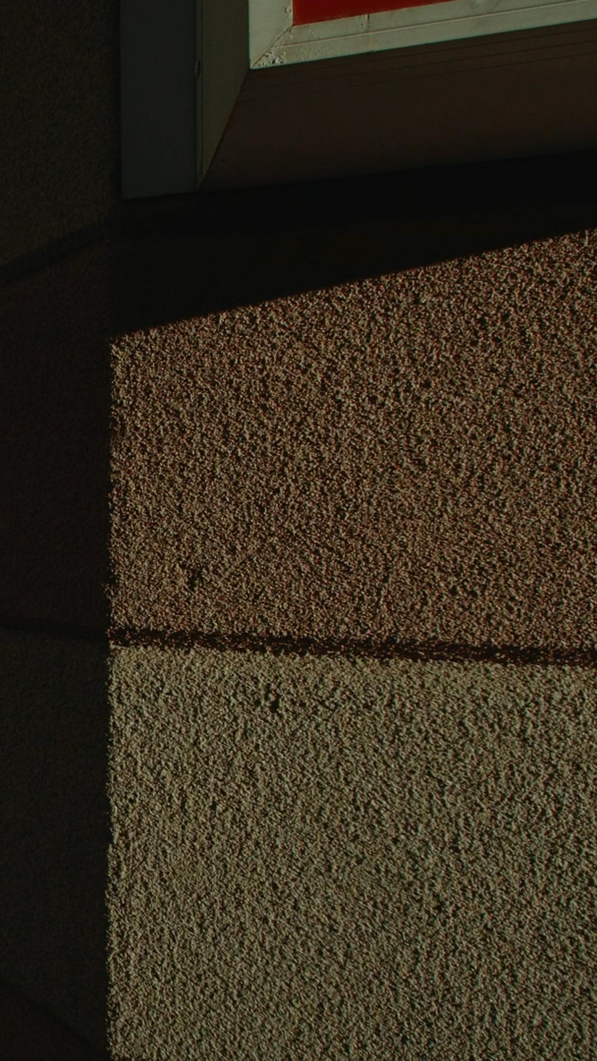 shadow of figure amongst pillars of a building