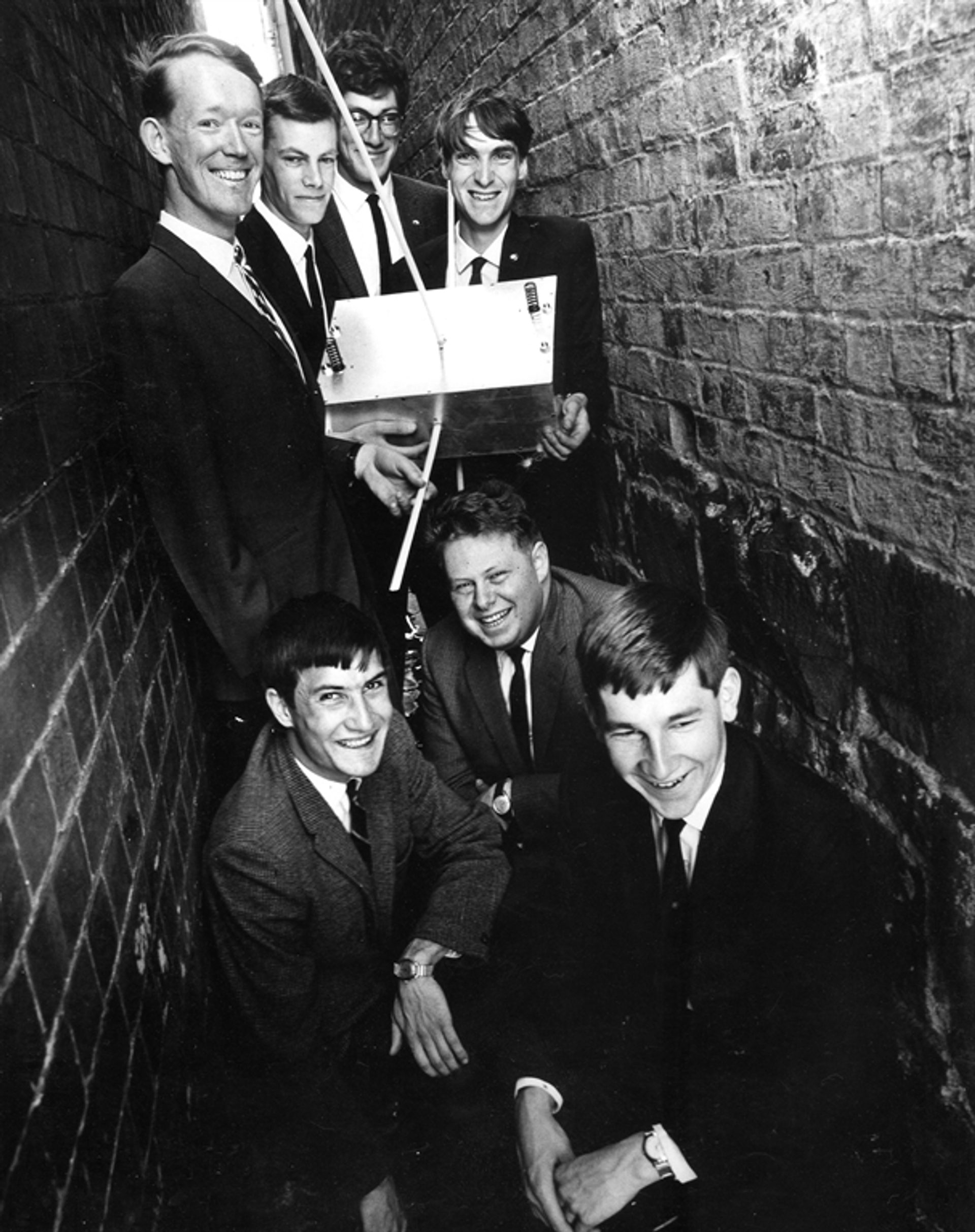 Suited students in a tight alleyway.
