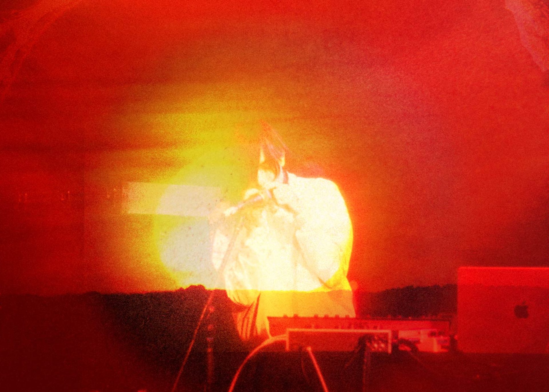 Photo bashed motion image with bright orange sunsets and natural textures over a silhouette of musician e fishpool.