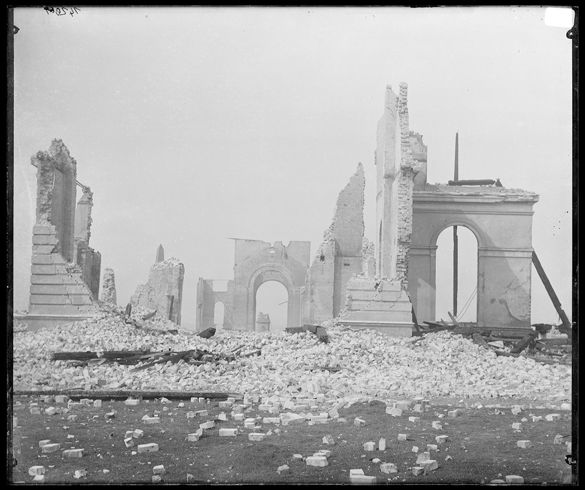 Black and white photo of a collapsed brick and stone building