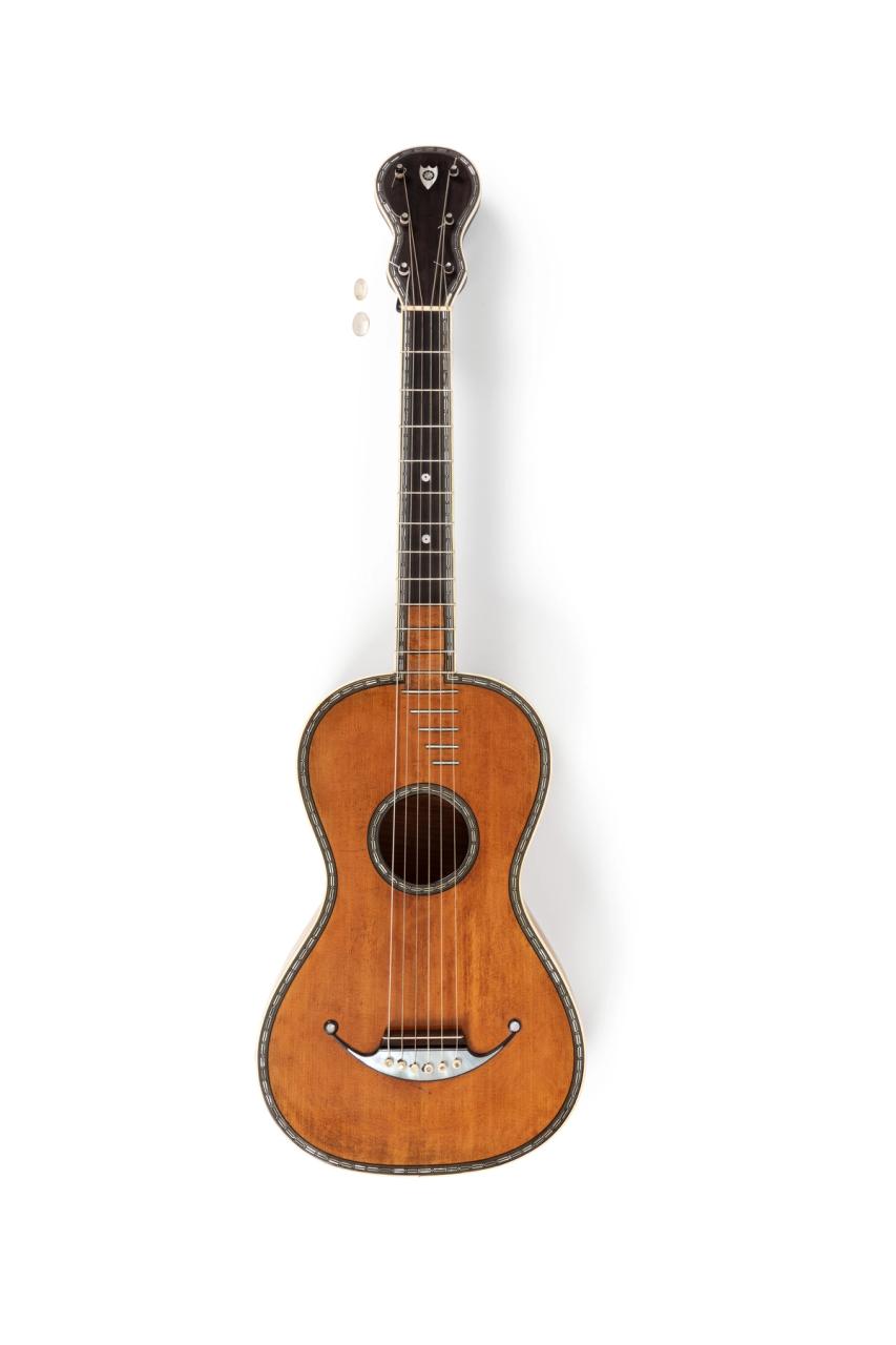Acoustic guitar made of various woods and mother-of-pearl from France.