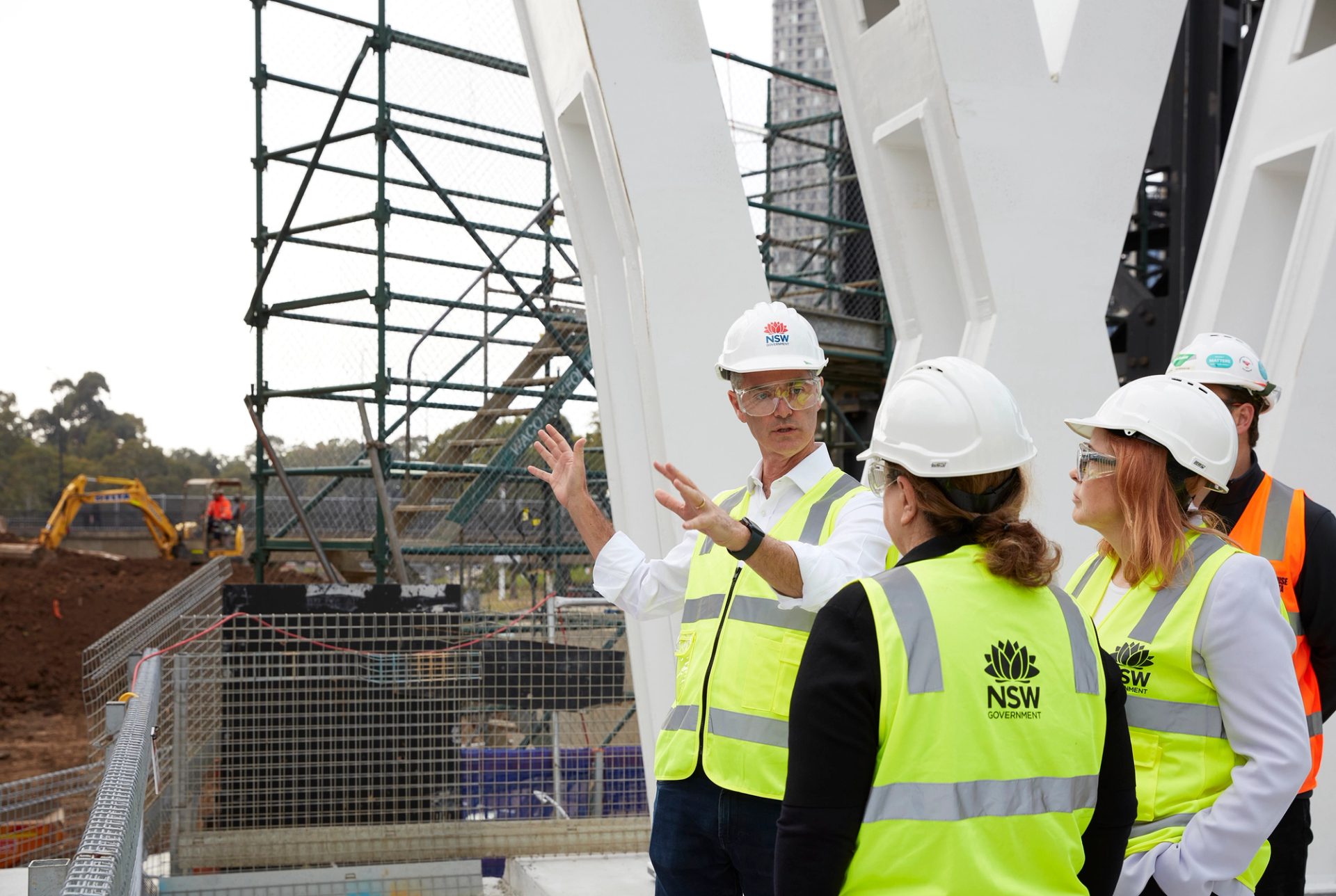 people in hard hats and hi-vis on a construction site