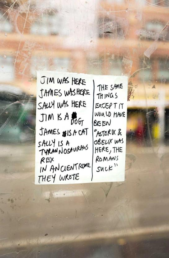 Note reading “JIM WAS HERE, JAMES WAS HERE, SALLY WAS HERE, JIM IS A DOG, JAMES IS A CAT, SALLY IS A TYRANNOSAURUS REX IN ANCIENT ROME THEY WROTE THE SAME THINGS EXCEPT IT WOULD HAVE BEEN ‘ASTERIX & OBELIX WAS HERE, THE ROMANS SUCK’”