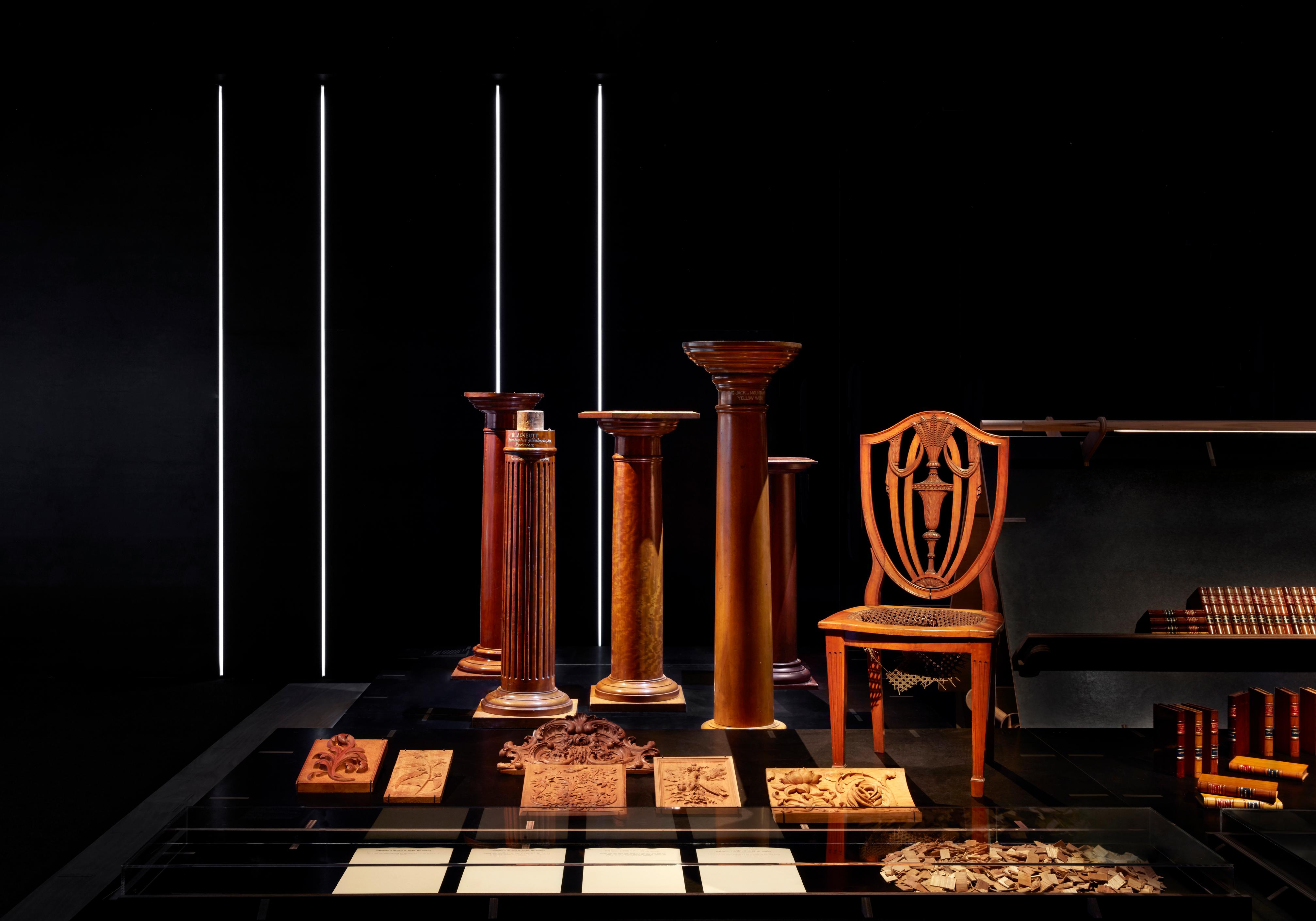 A collection of timbre furniture including a chair, pillars, and engravings.