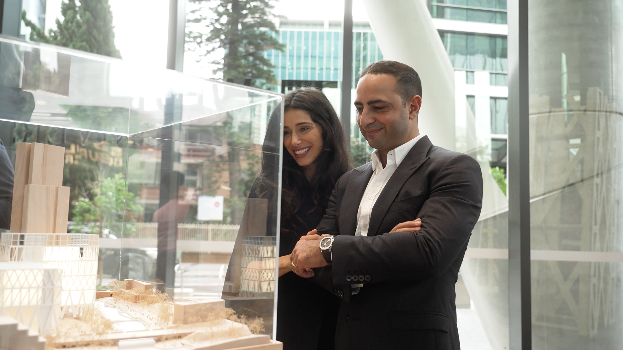 Two people look at a model of Powerhouse Parramatta.