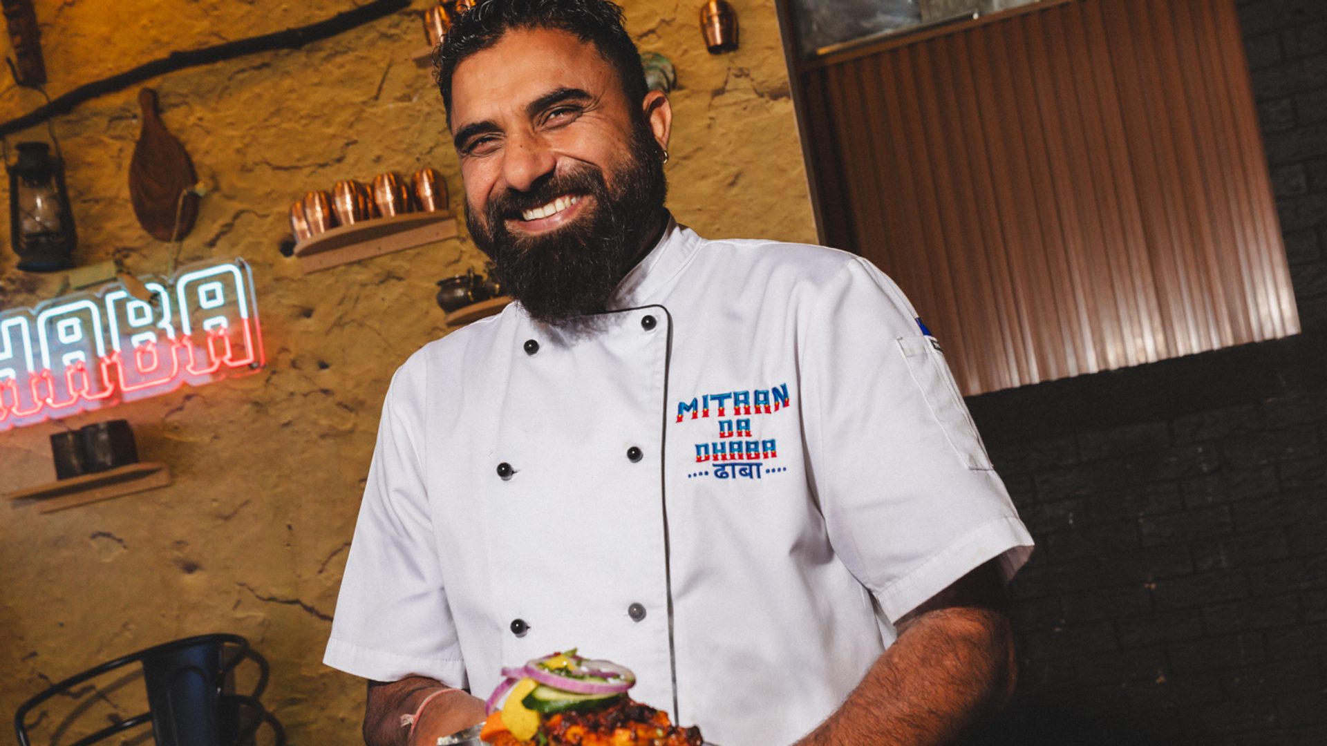 Man holding a plate smiling.