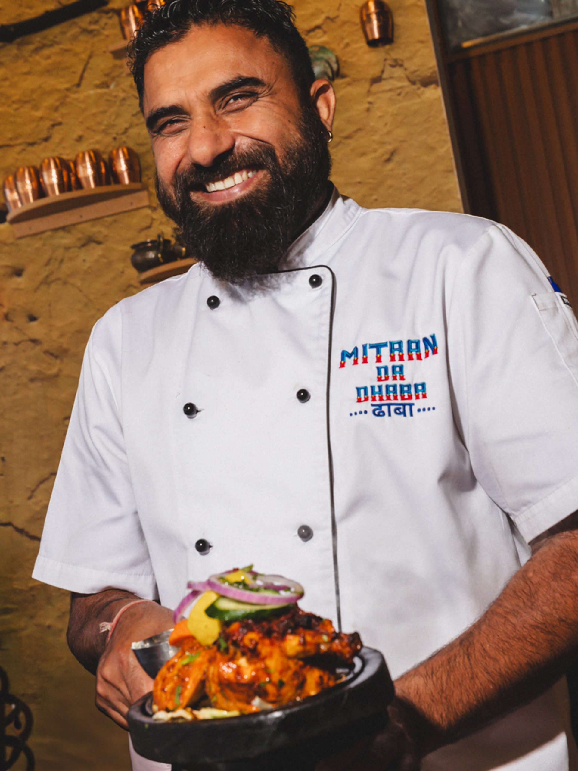 Man holding a plate smiling.