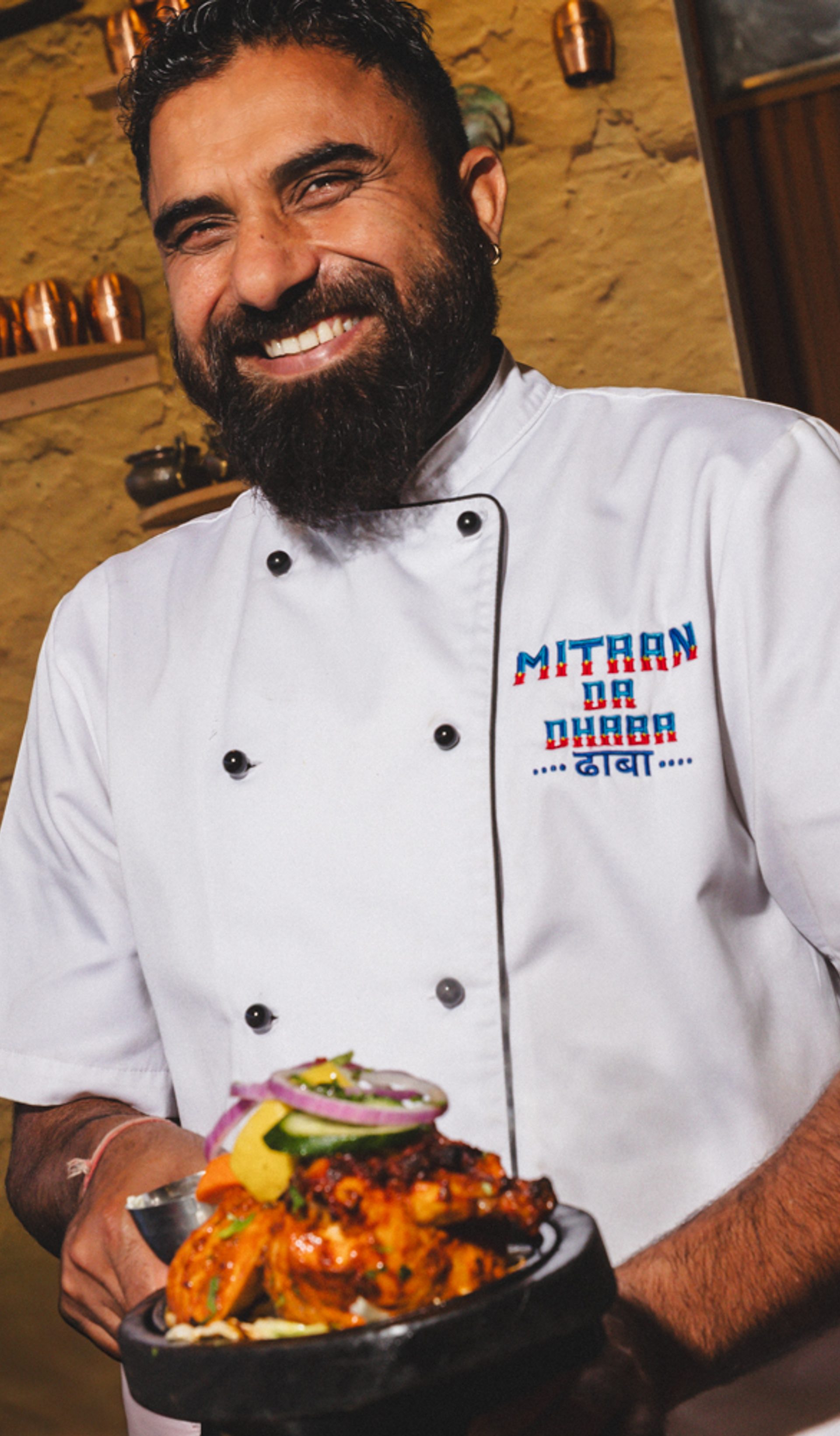 Man holding a plate smiling.