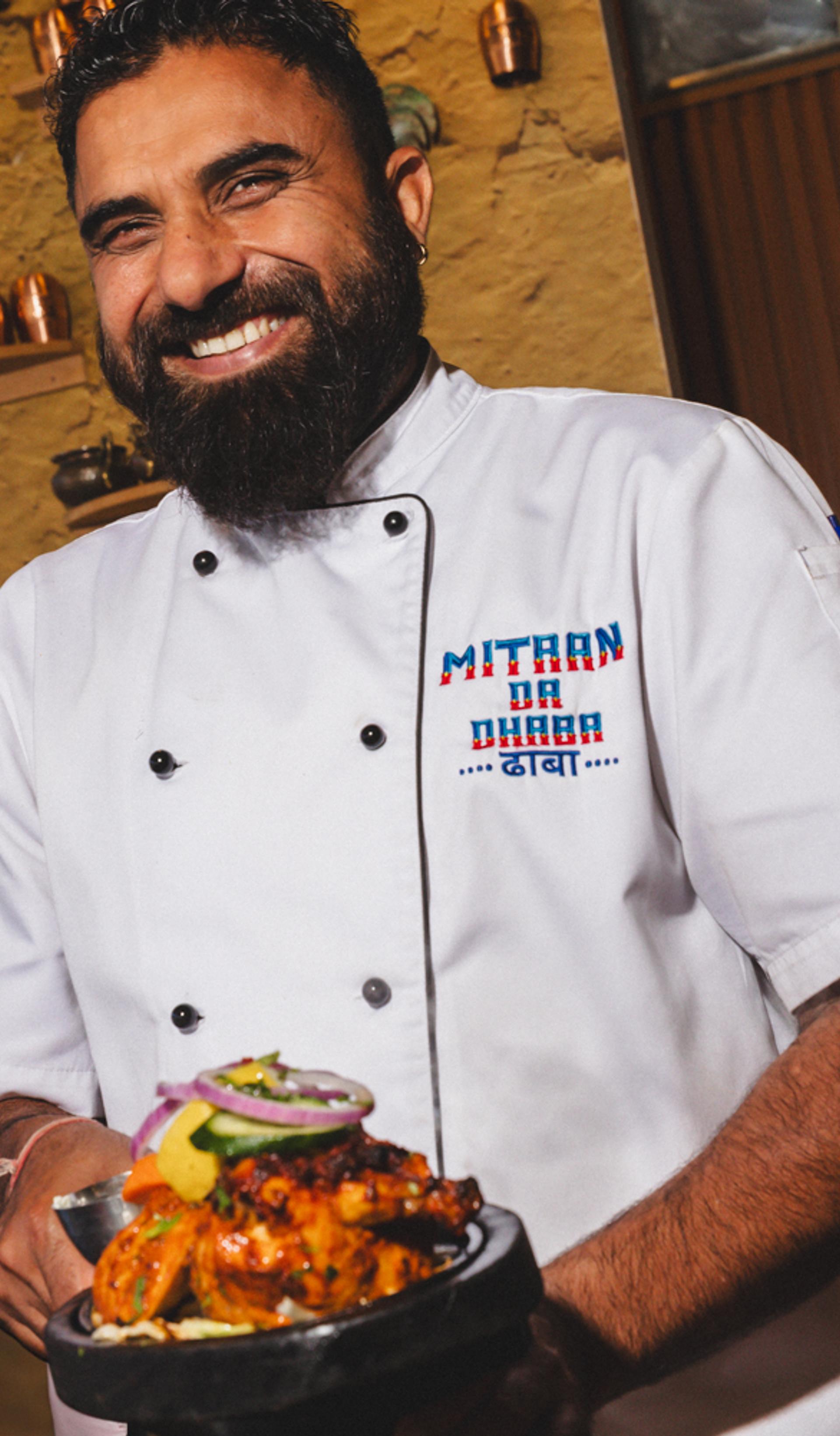 Man holding a plate smiling.