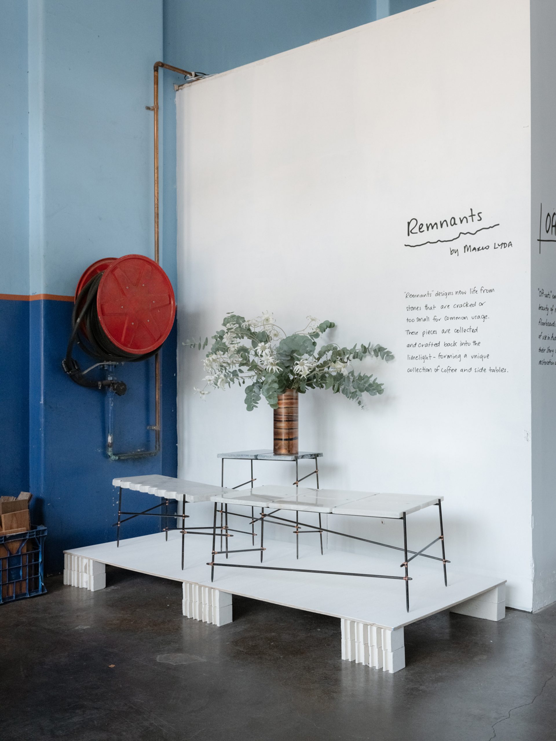 Tables of marble on display next to a fire hydrant