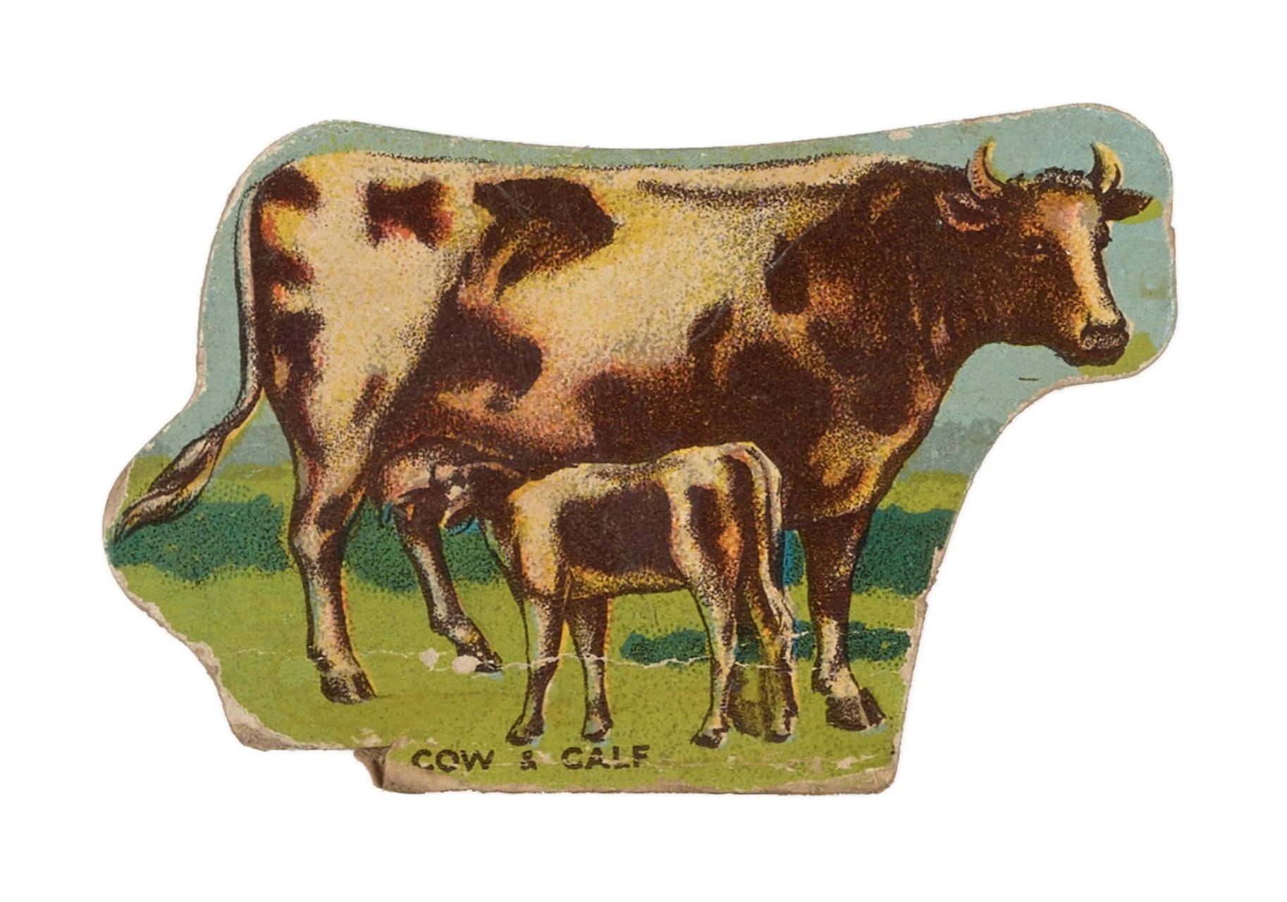 A game piece of a cow and a suckling calf.