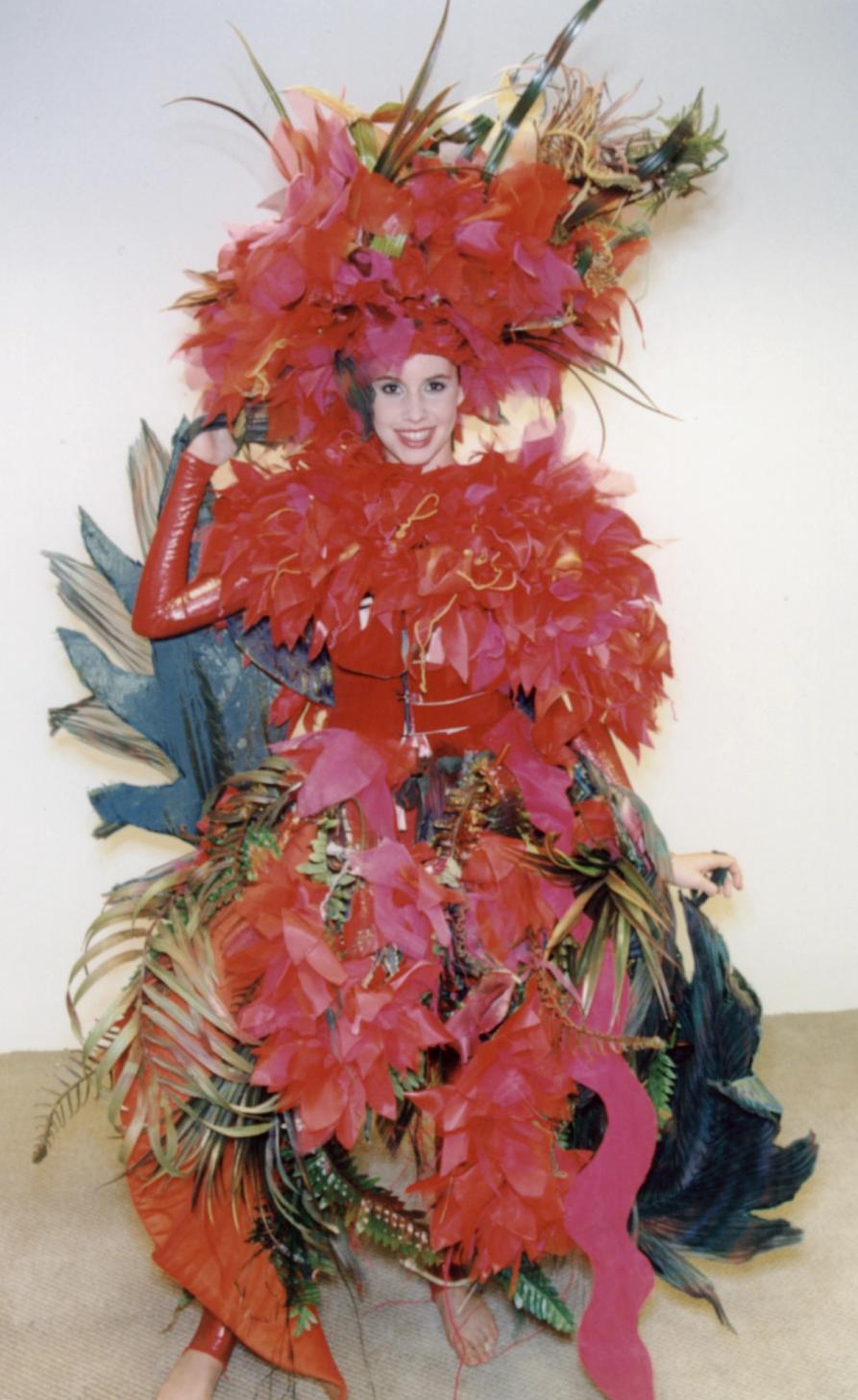 A woman dress in Red feathered costume dress and head piece.