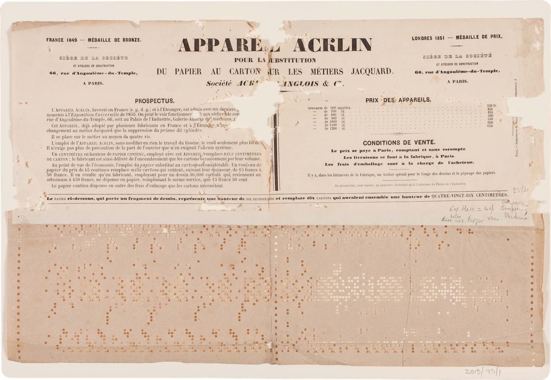 Two pieces of paper with black lettering and punch card holes.
